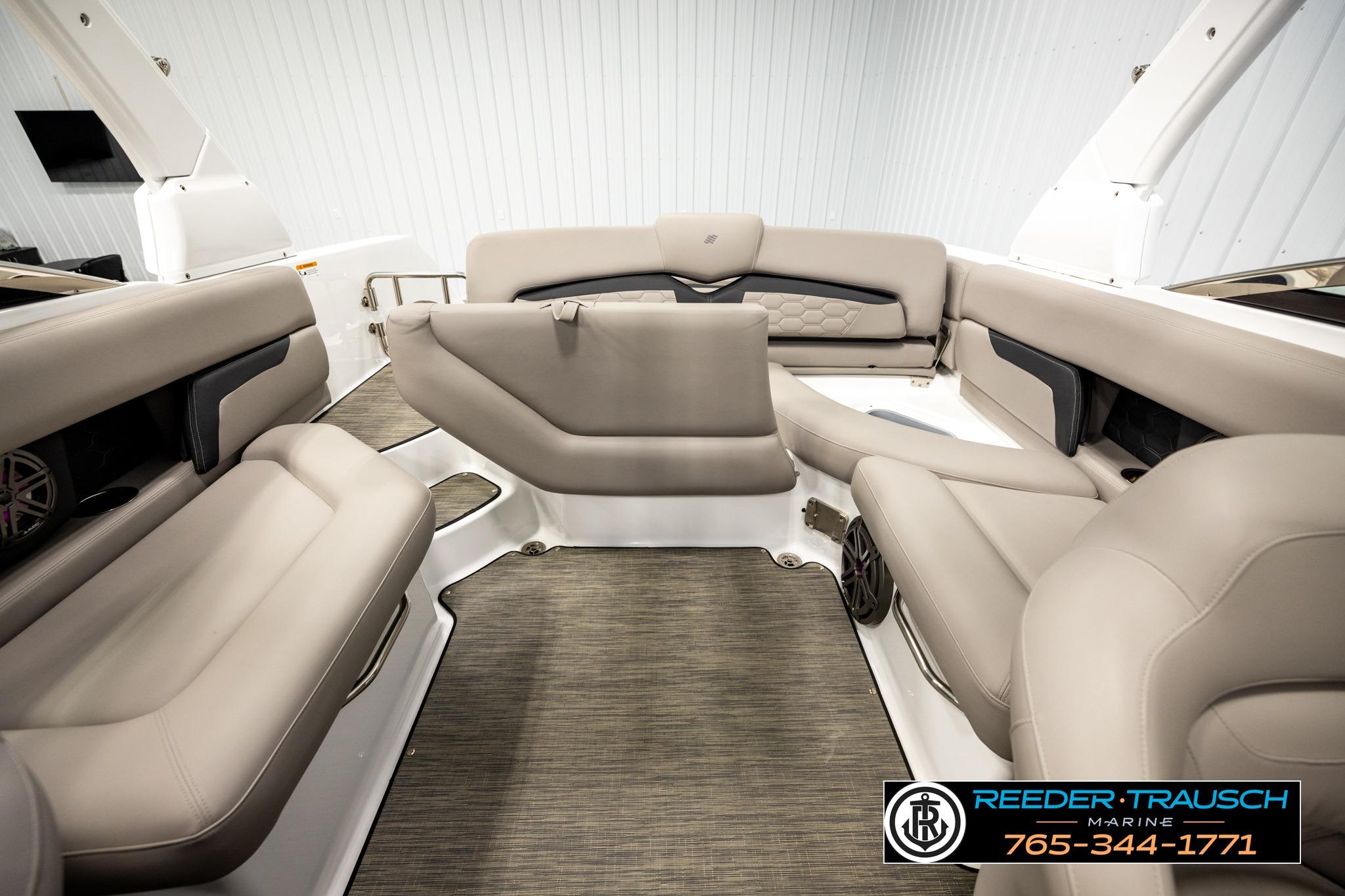 2024 FOURWINNS HD5 Surf boat interior with beige seating and modern design.