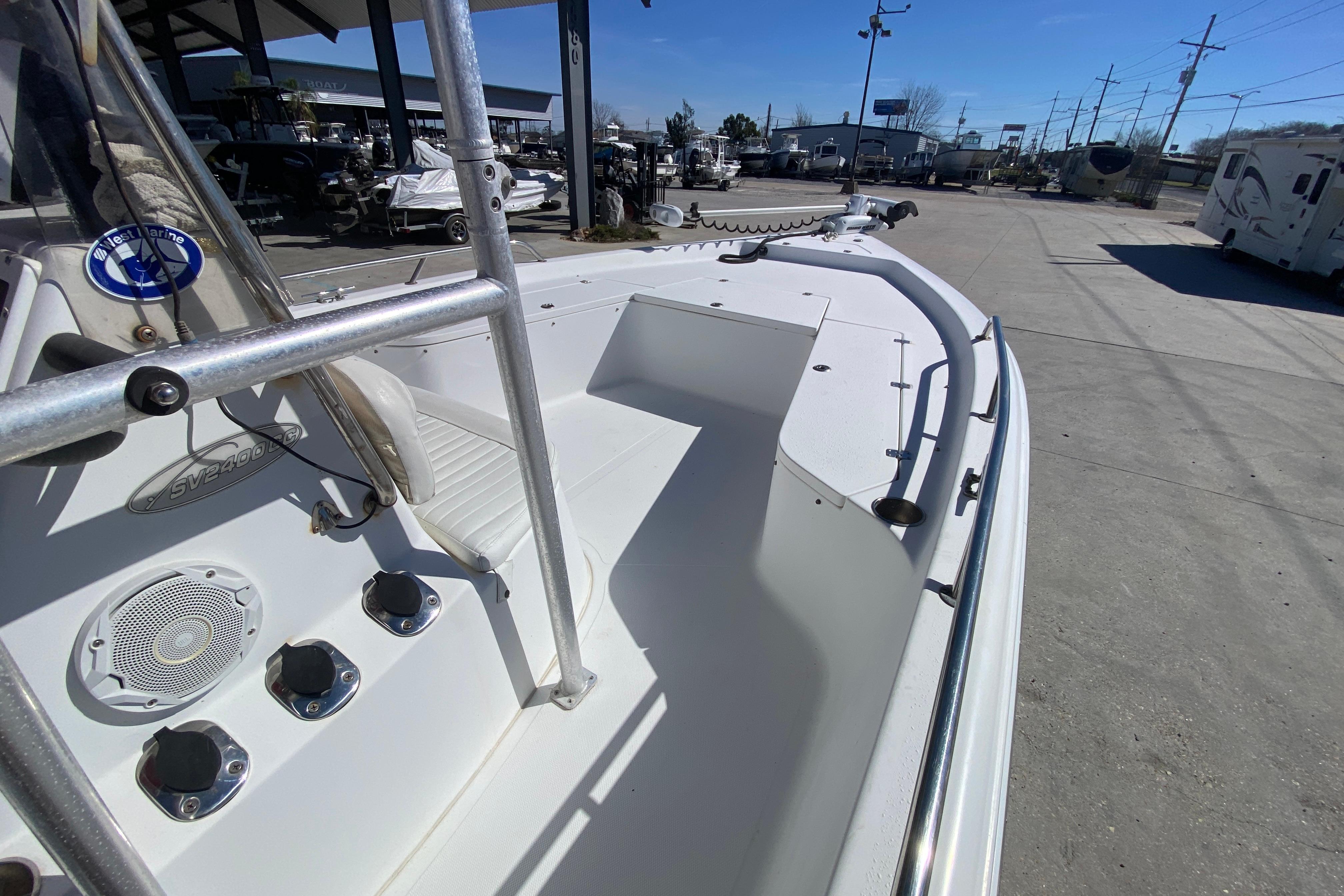2005 Sea Pro SV2400CC Bay Boat, white deck, marina background, sunny day.