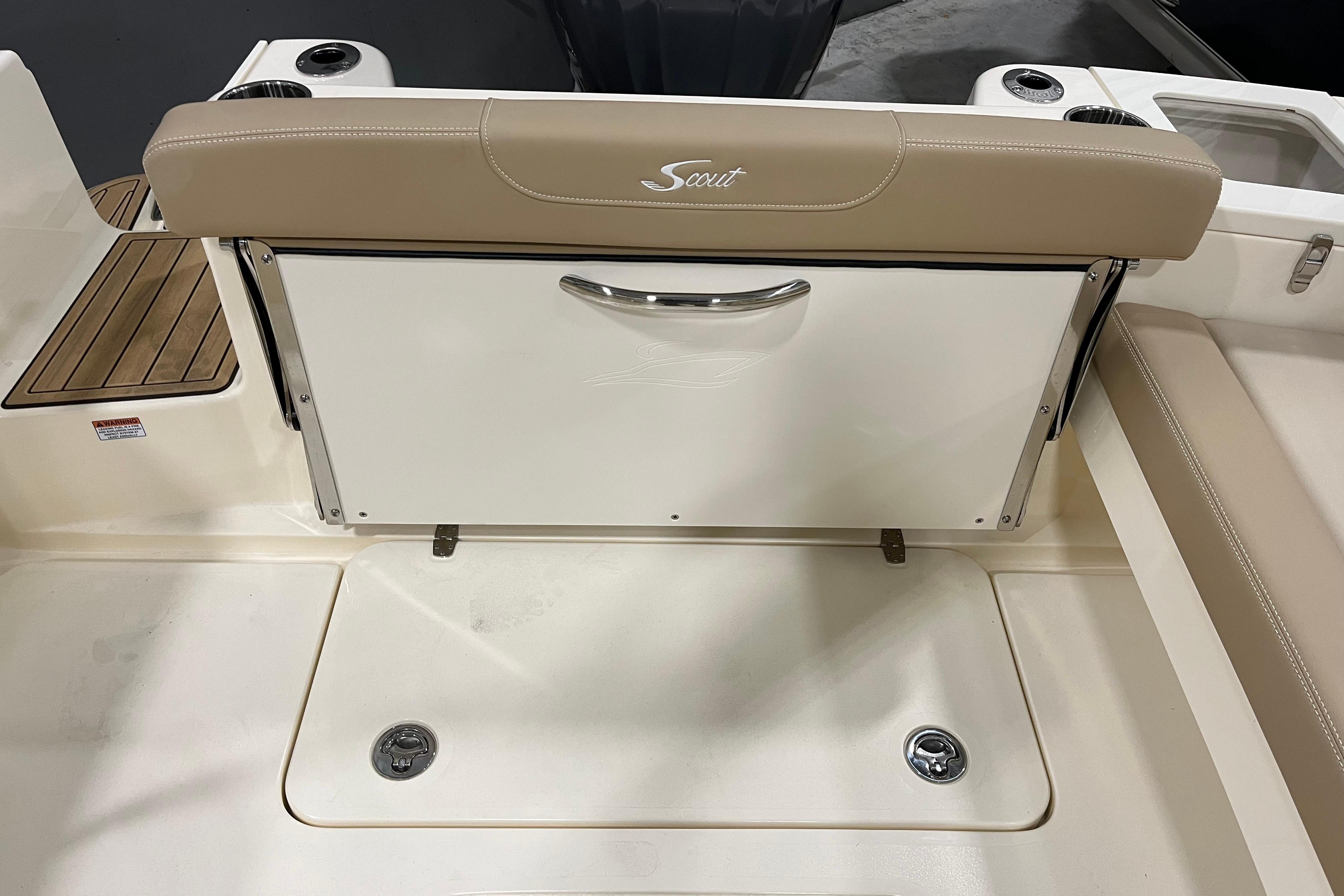 2025 Scout 215 Dorado boat interior with beige seating and storage compartment.