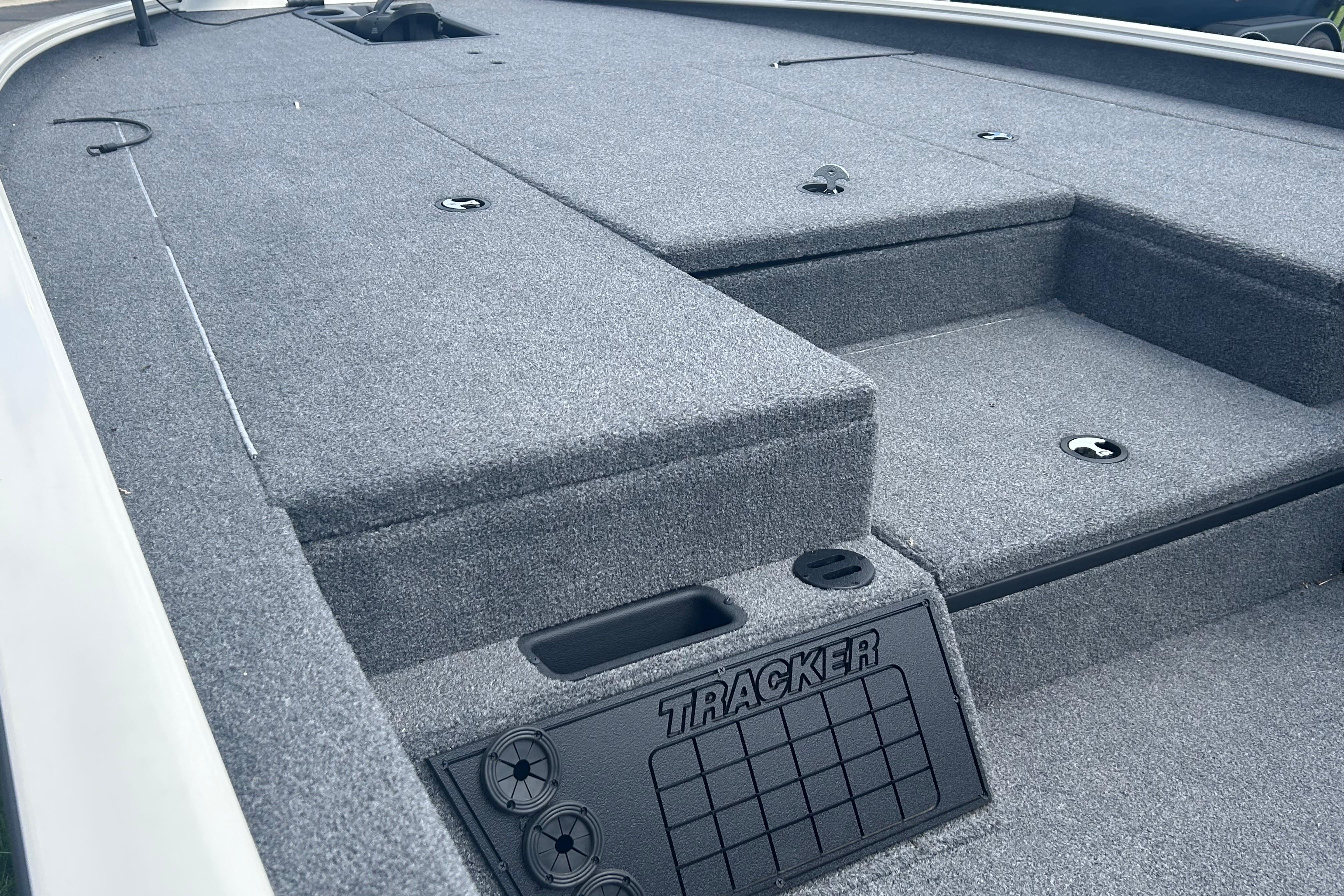 2025 Tracker Savage 215 boat deck with gray carpet and storage compartments.