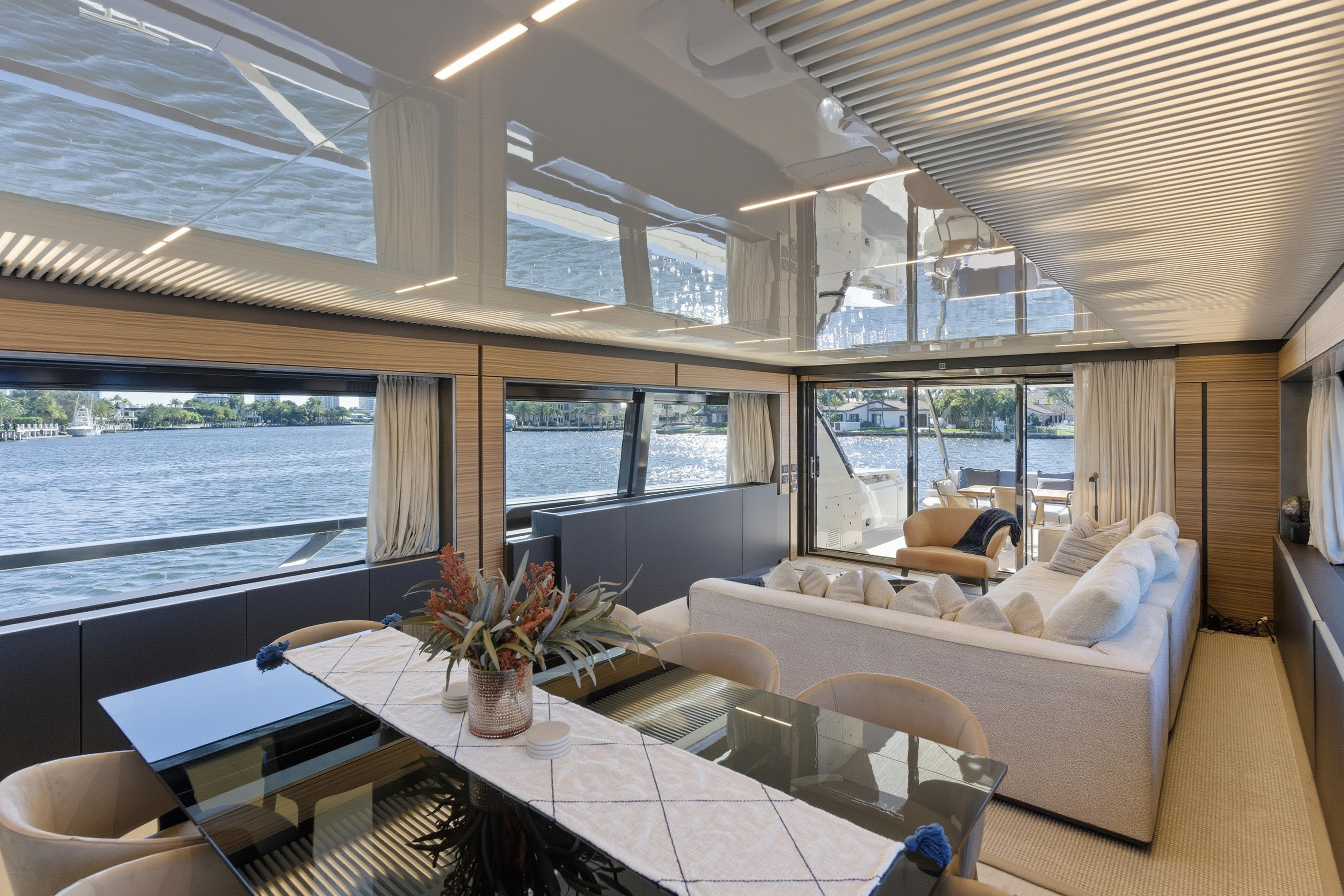 Luxurious interior of 2018 Ferretti Yachts 920 with elegant dining and seating area overlooking the water.