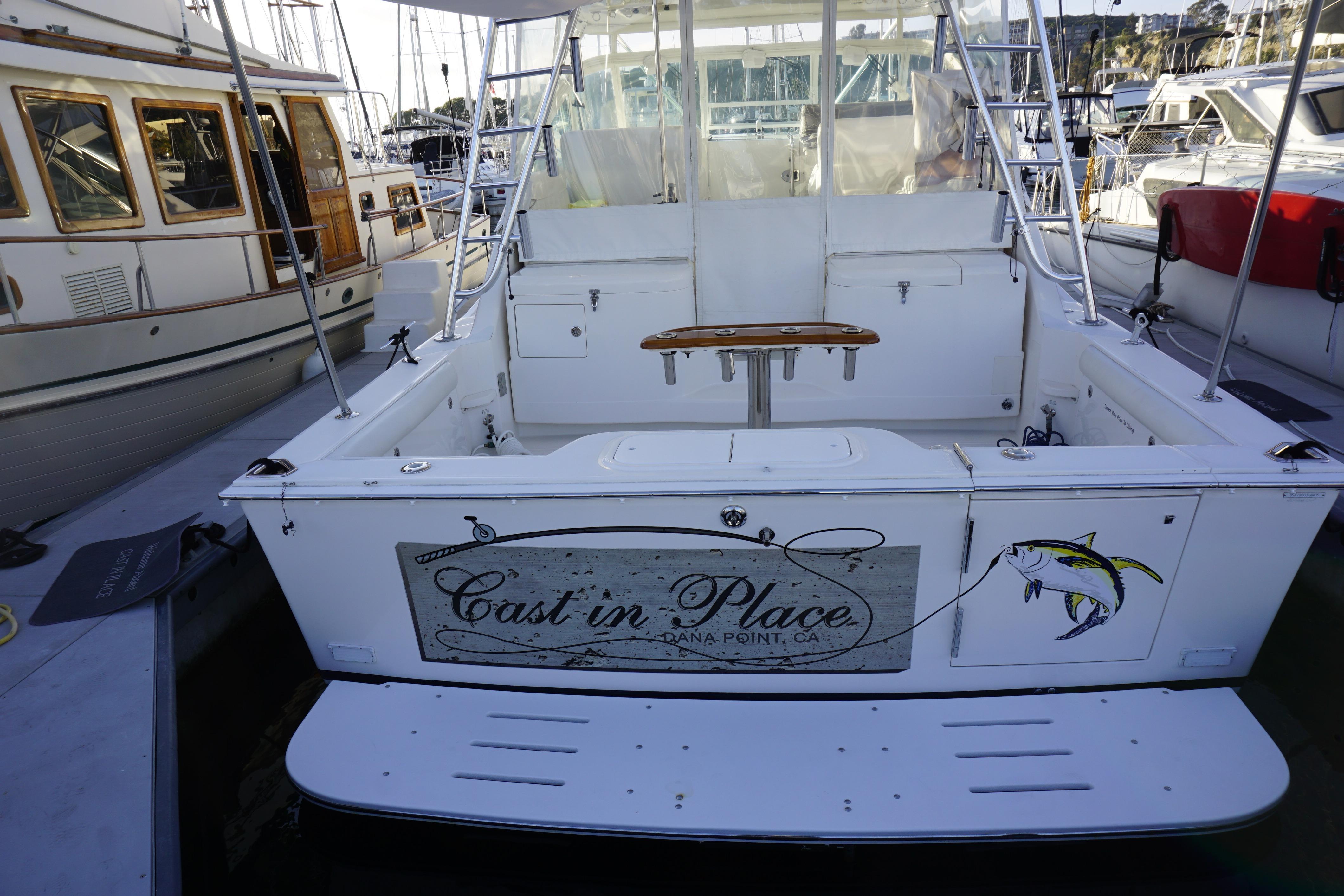 2005 Cabo 35 Express boat docked, featuring "Cast in Place" signage at Dana Point, CA.