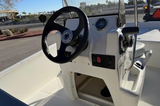 2026 Mako Pro Skiff 15 CC boat console with steering wheel and controls.
