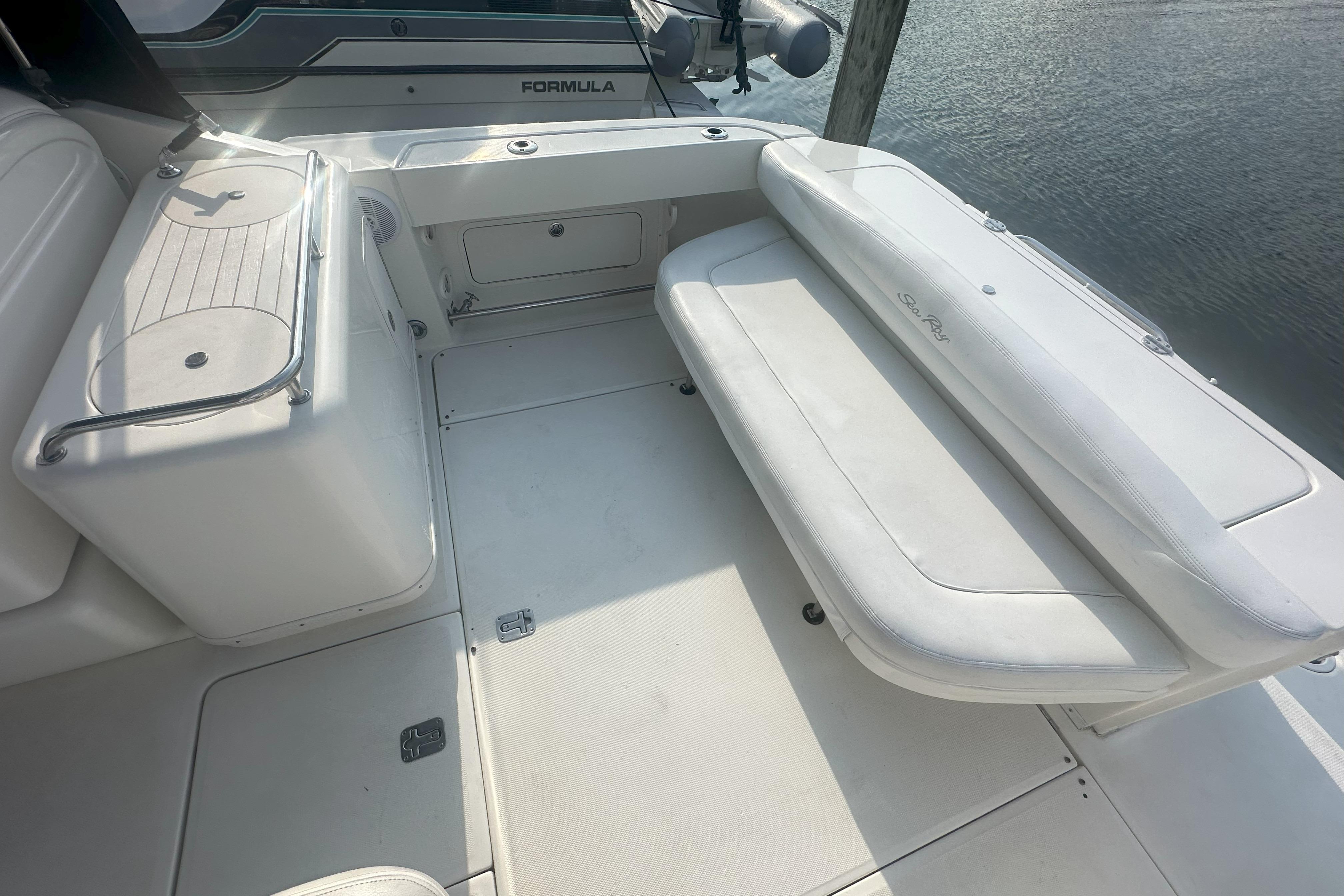 2006 Sea Ray 290 Amberjack boat interior with white seating and storage compartments.