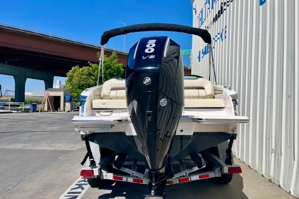 2025 Regal LX2 boat with powerful 200 V6 engine, parked outdoors on a trailer.