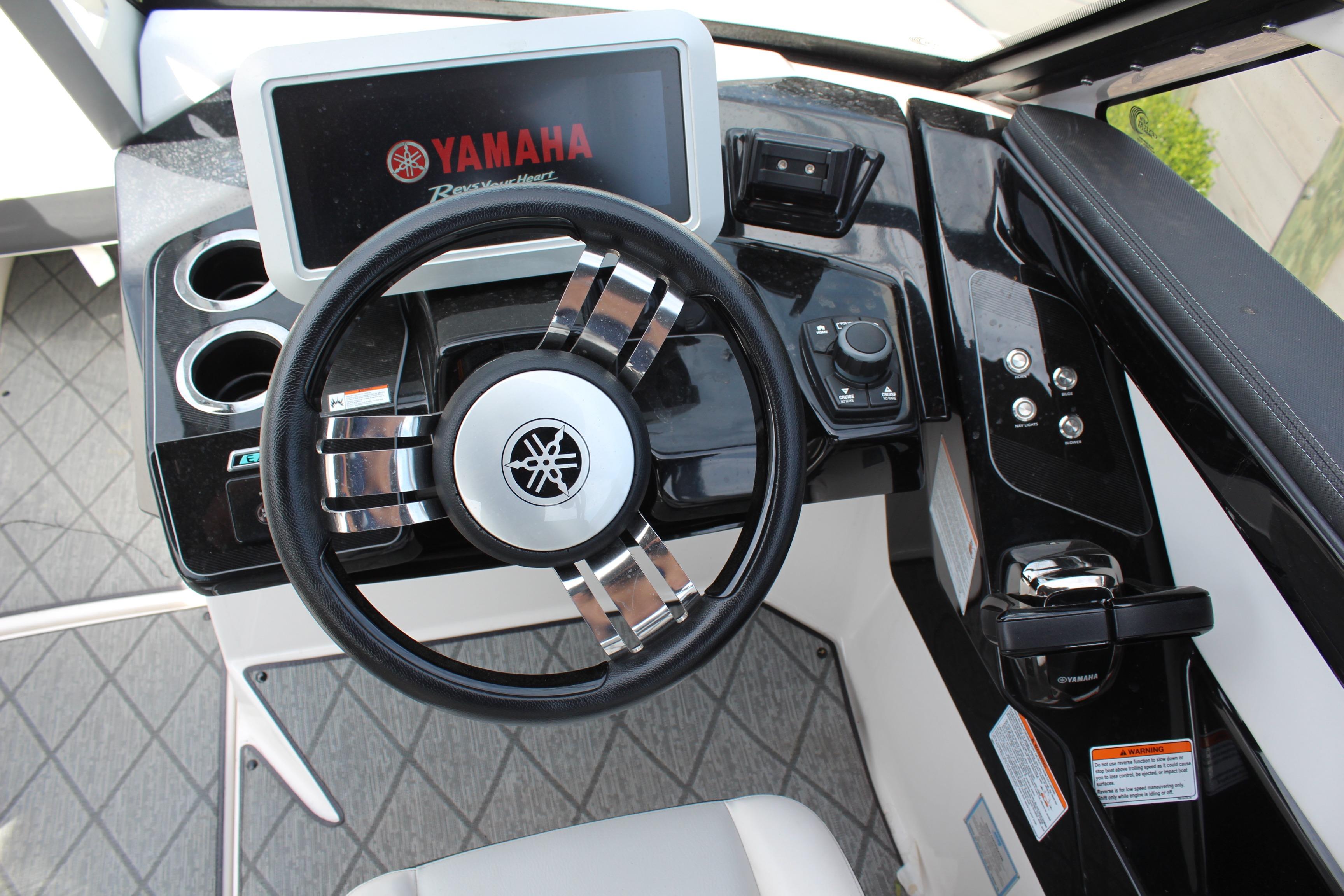 2020 Yamaha Boats 275SE dashboard with steering wheel and control panel.
