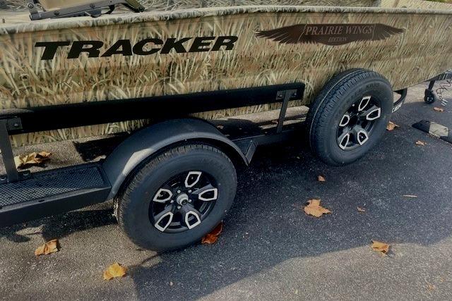 2026 Tracker Grizzly 1650 T Prairie Wings Edition boat trailer with camouflage design and black wheels.