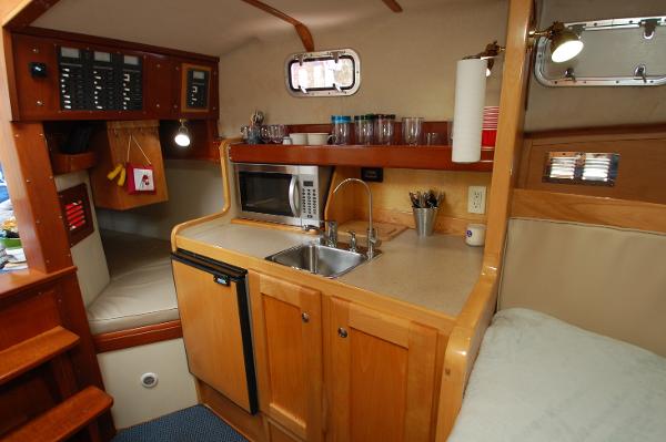 Interior of a 2005 Fox Island Thirty - Sedan Cruiser with kitchen and sleeping area.