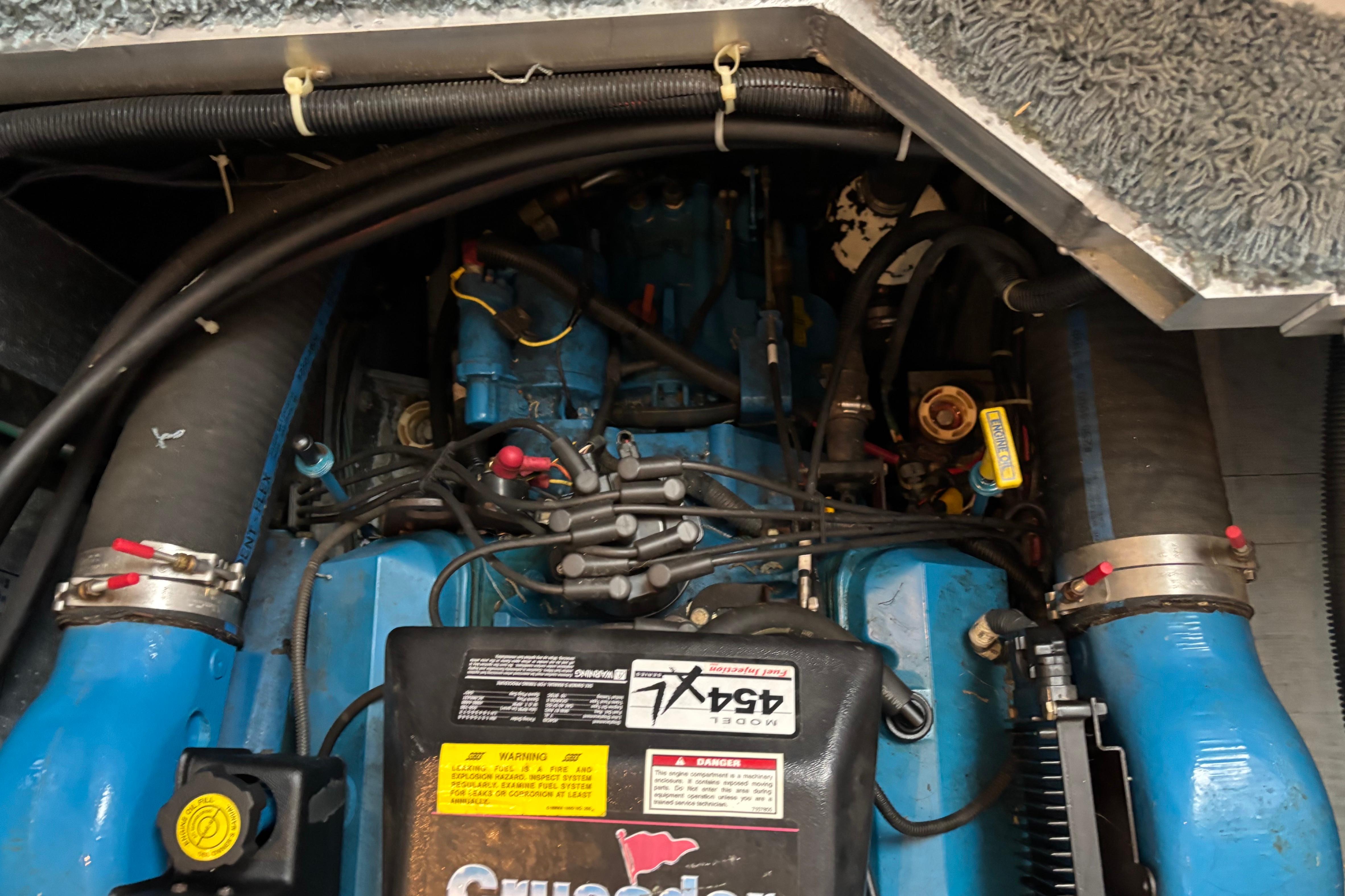 Engine compartment of a 1997 Carver 400 Cockpit Motor Yacht, showcasing mechanical components.
