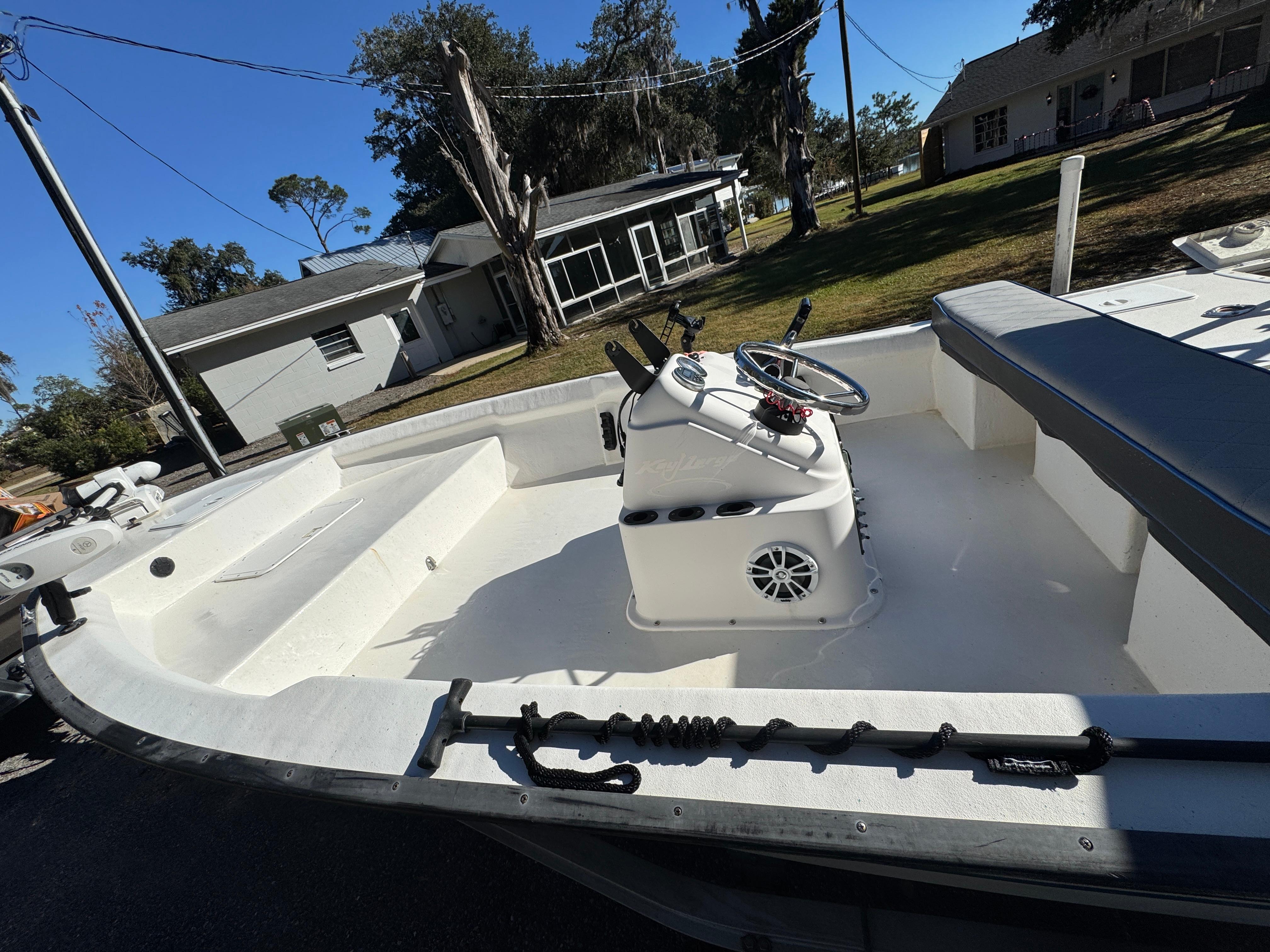 2006 Key Largo 174 boat with center console, parked outdoors near residential area.