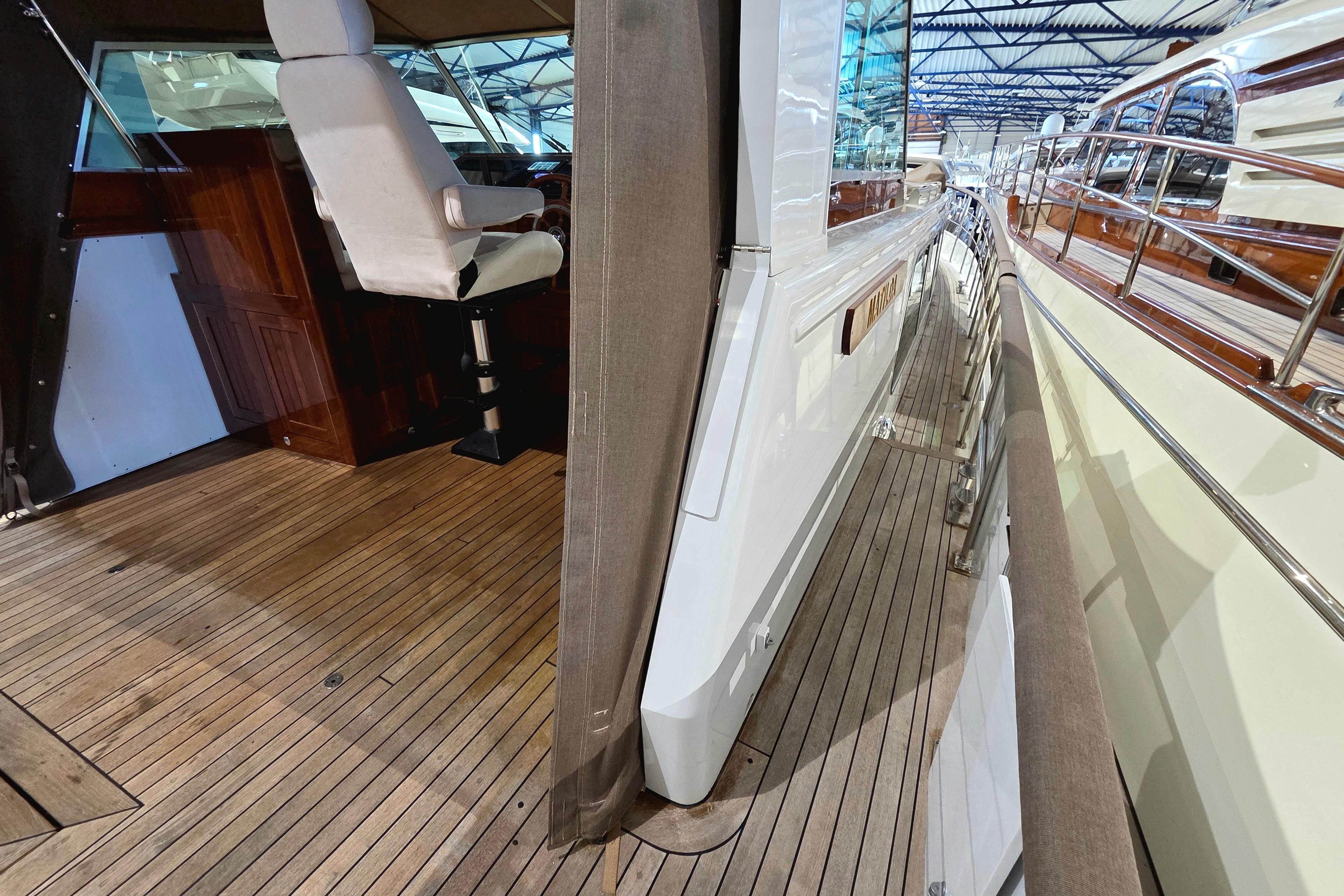 Interior and deck view of 1999 Super Van Craft 14.95 yacht, showcasing elegant wood finishes.