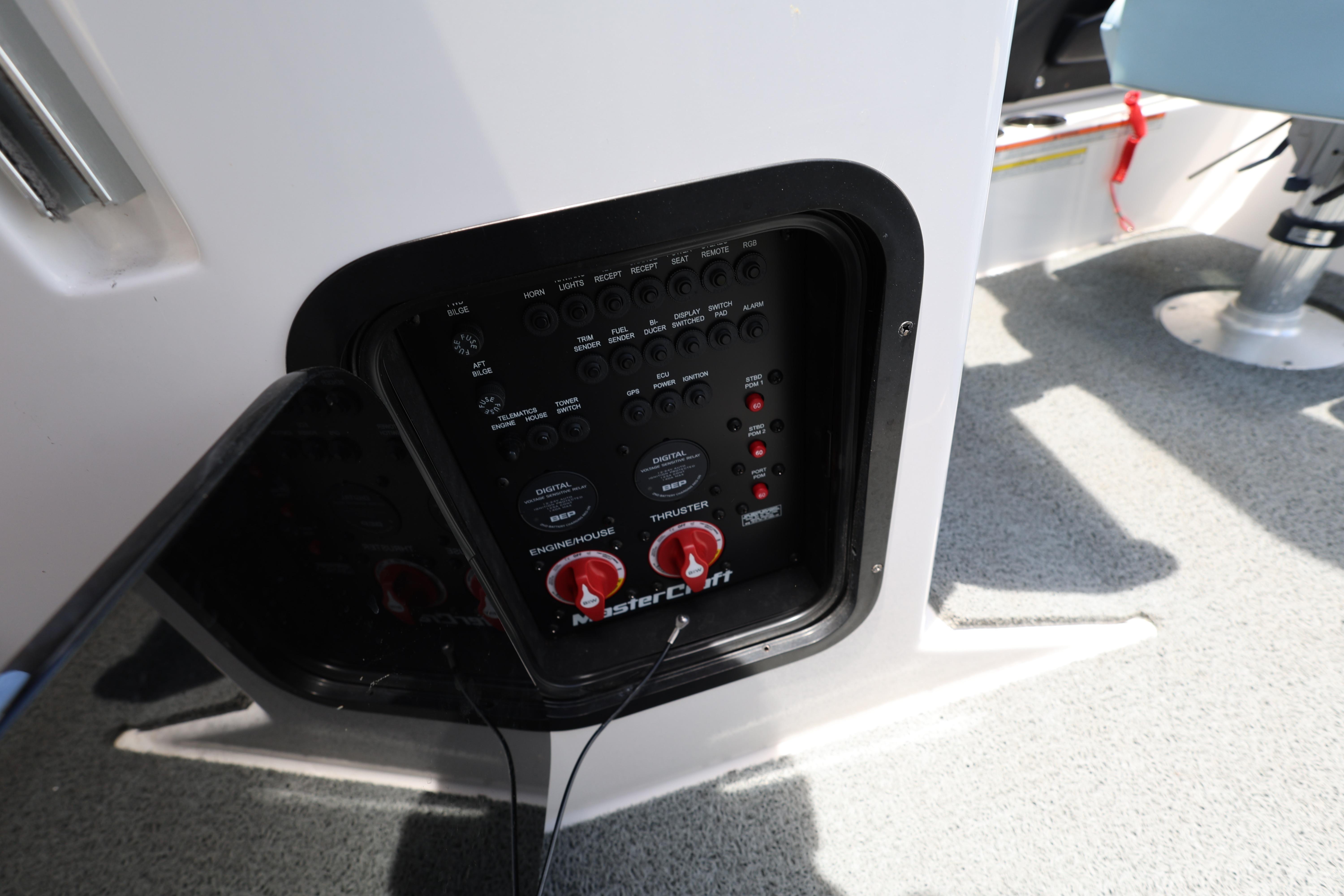Control panel of 2023 MasterCraft X24 boat, featuring switches and dials.