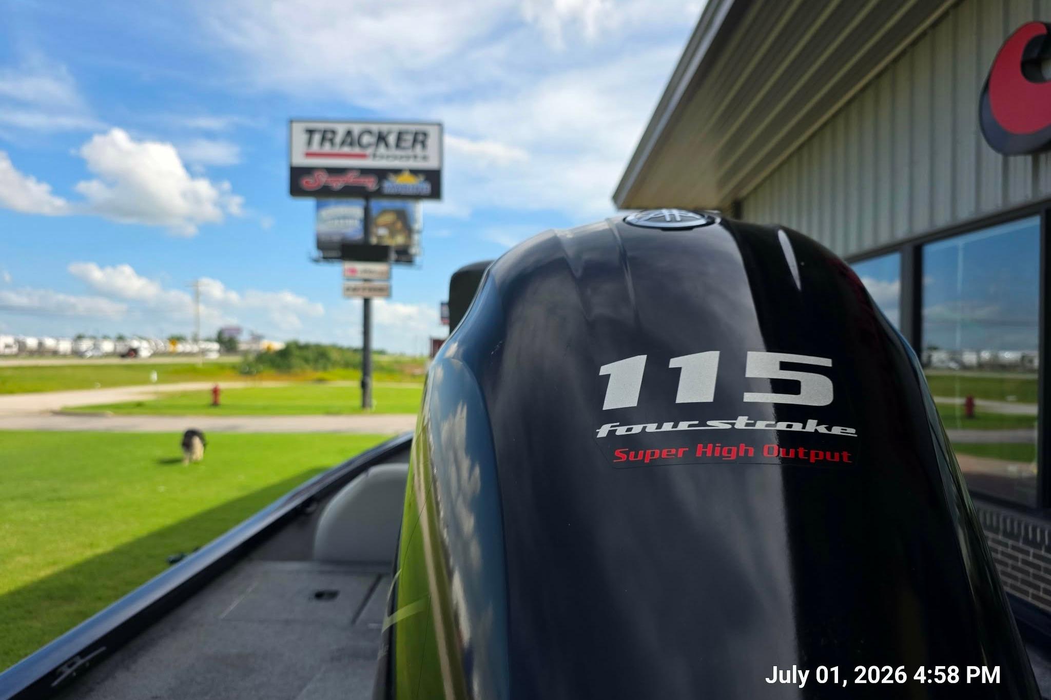 Outboard motor on a 2017 G3 Sportsman 18 boat near dealership, sunny day.