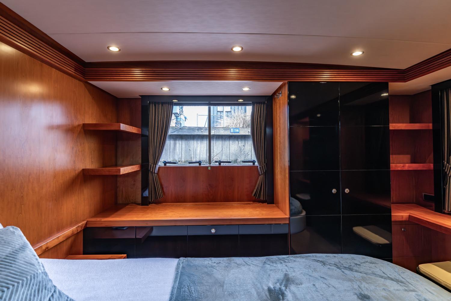Luxurious interior of 2005 Van der Valk Continental 1900 yacht with wood paneling and modern design.