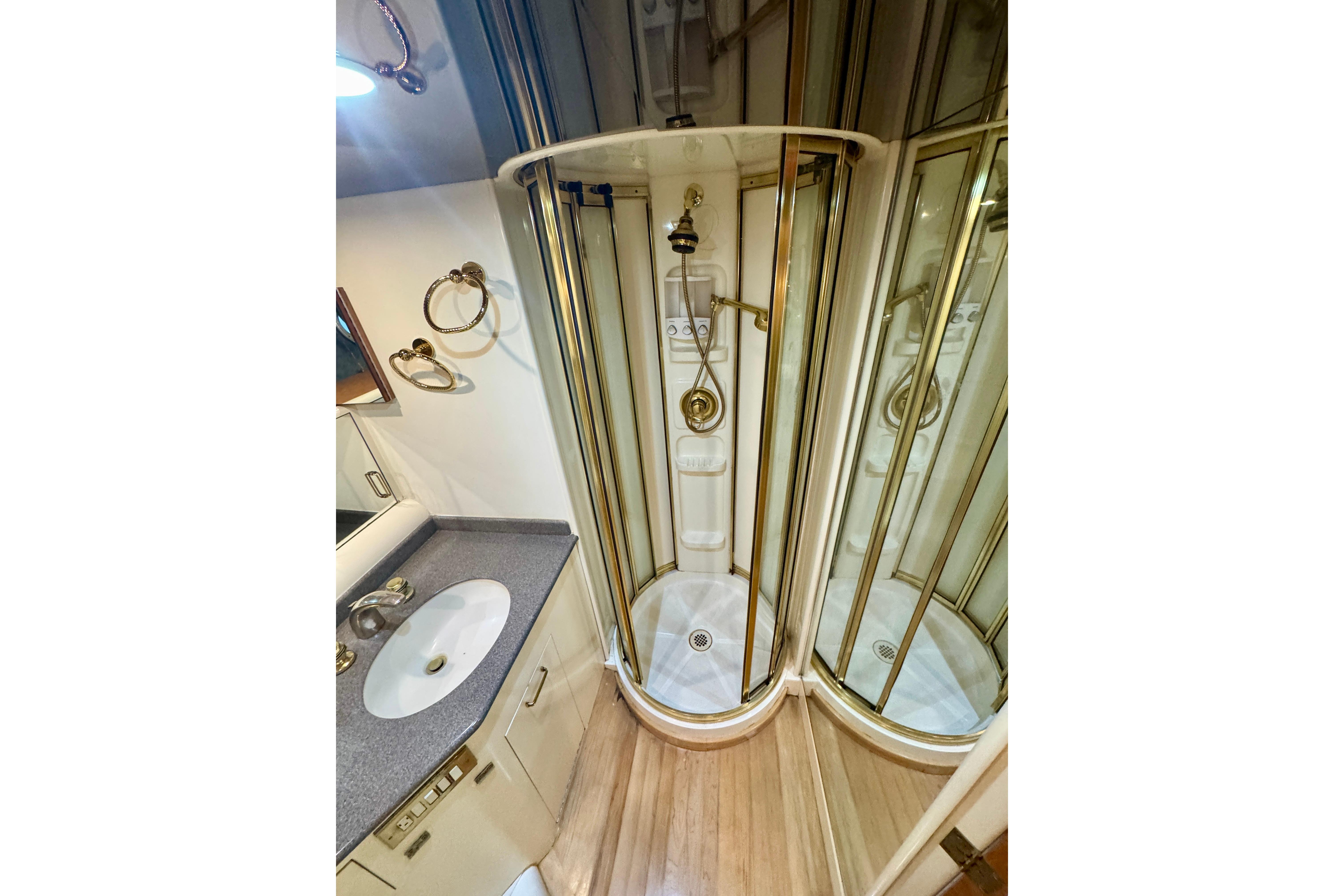 Luxurious bathroom in 1995 Queenship 62 Pilothouse Motor Yacht with shower and vanity.
