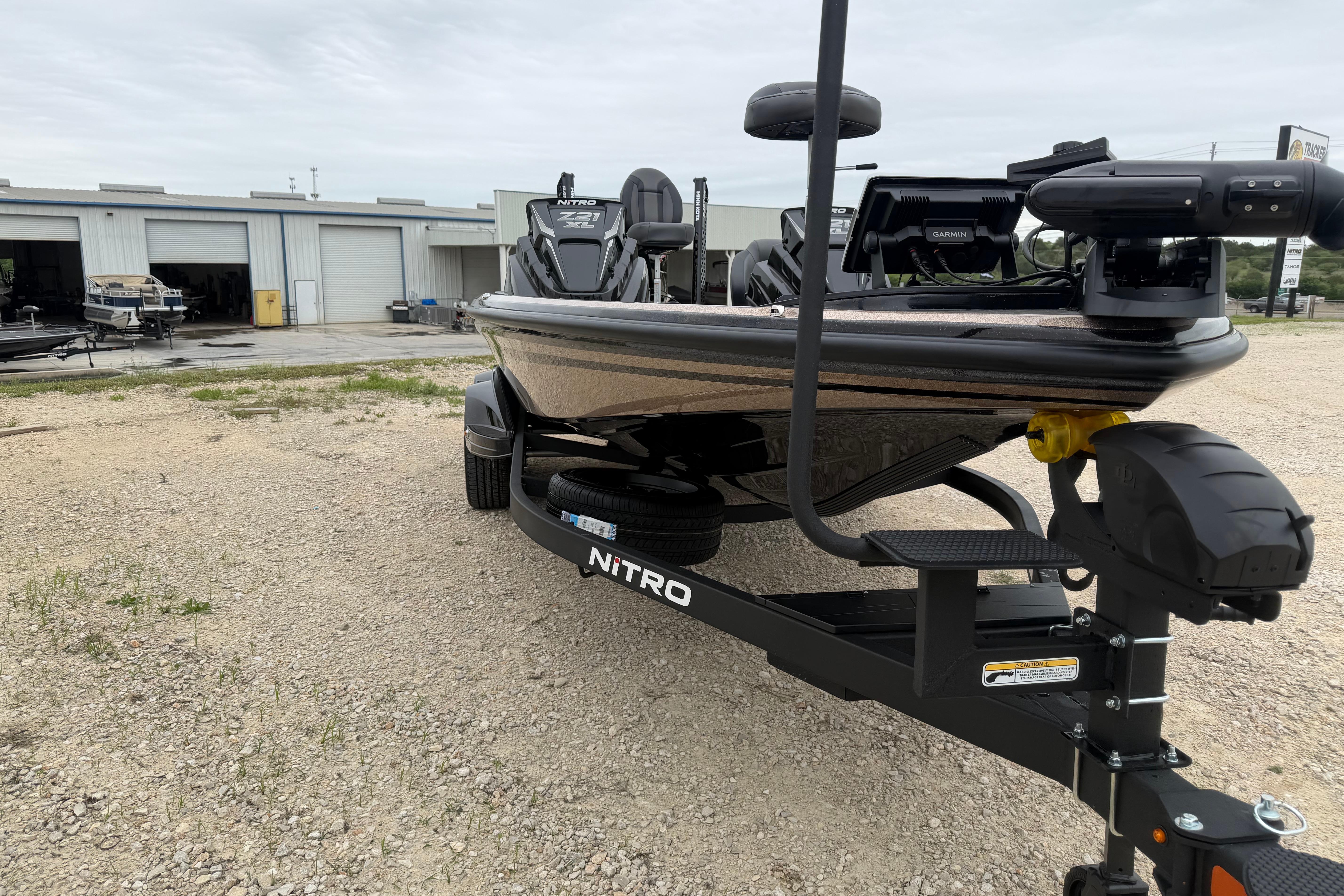 2026 Nitro Z21 XL Pro boat on trailer, parked outside a garage.
