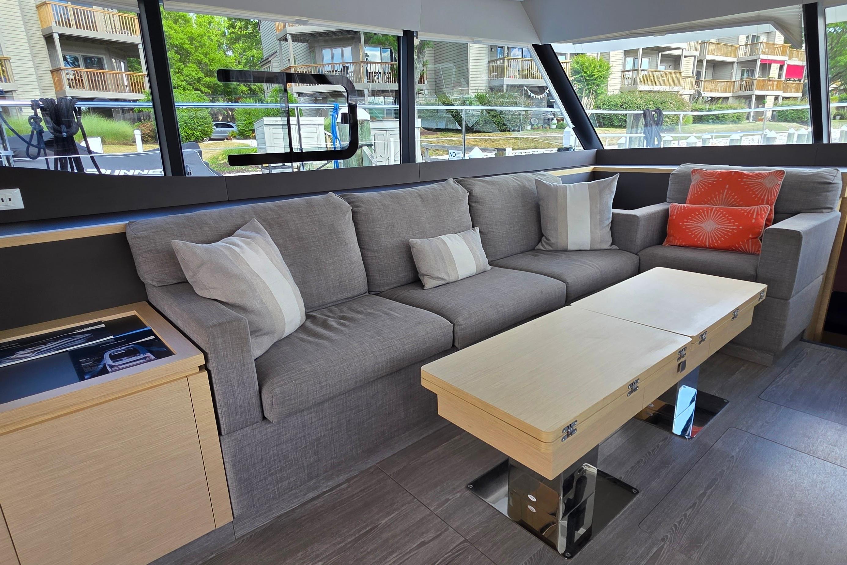 Luxurious interior of 2018 Fountaine Pajot Motor Yacht 44 with modern sofa and table.