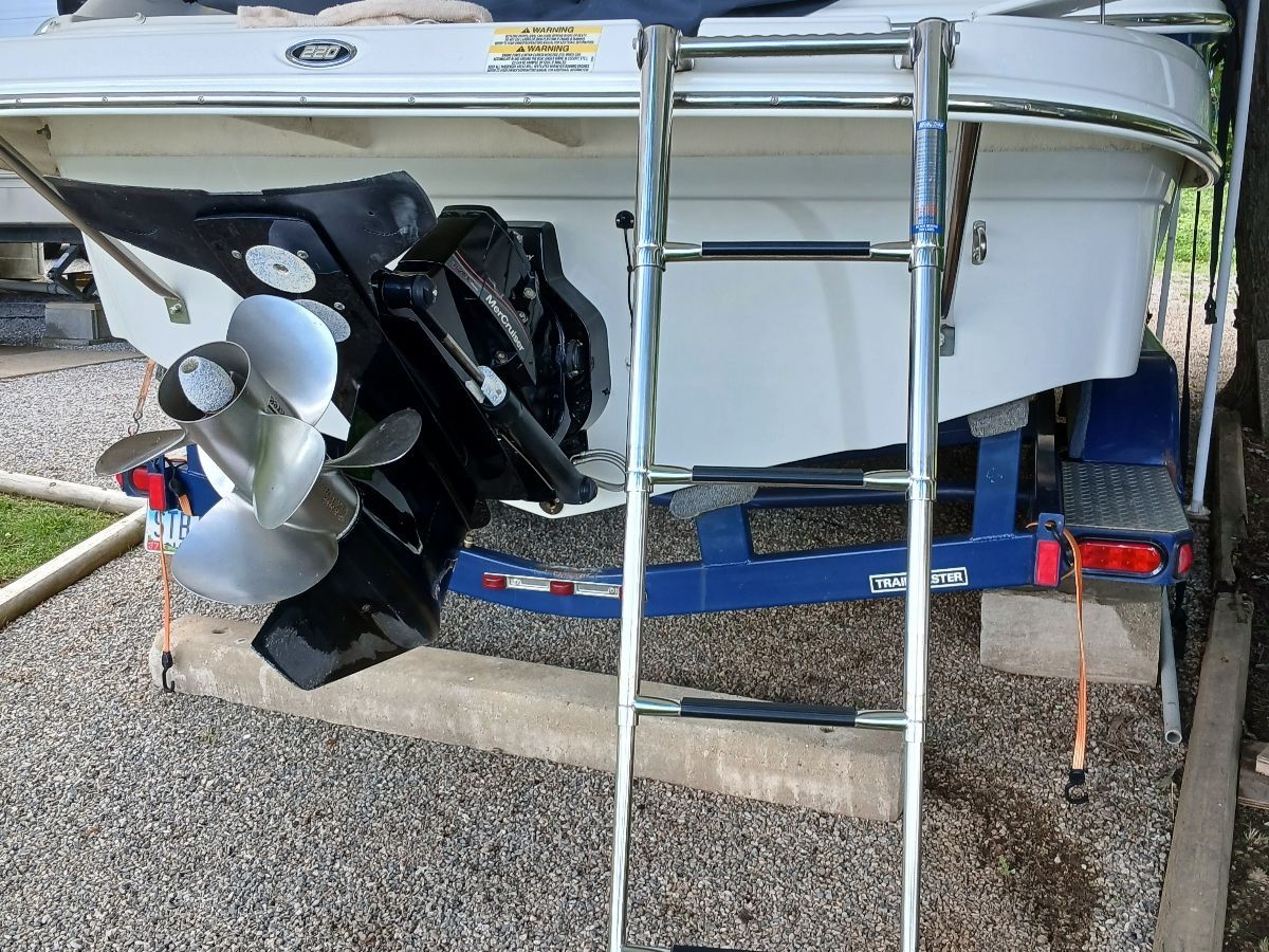 Rear view of a Crownline 220 EX boat with propeller and ladder.