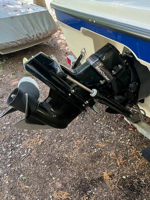 A Bayliner 185 boat engine on dry ground, featuring a MerCruiser drive.