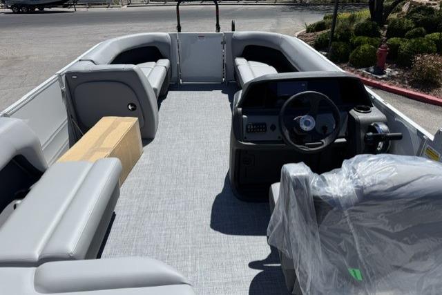 2026 Sun Tracker Party Barge 18 DLX interior with gray seating and steering console.