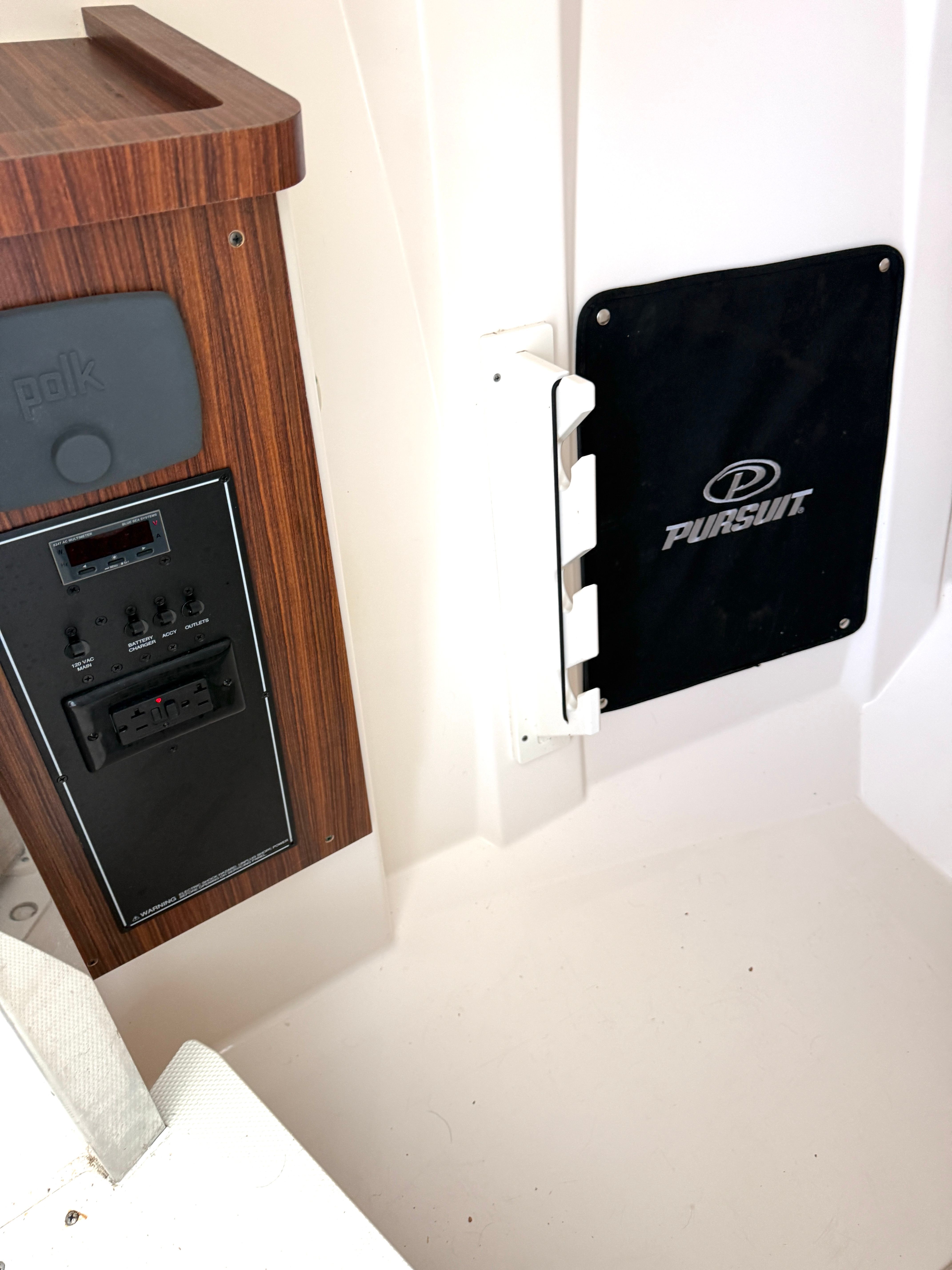 Interior view of a 2017 Pursuit DC 295 Dual Console with wood paneling and controls.