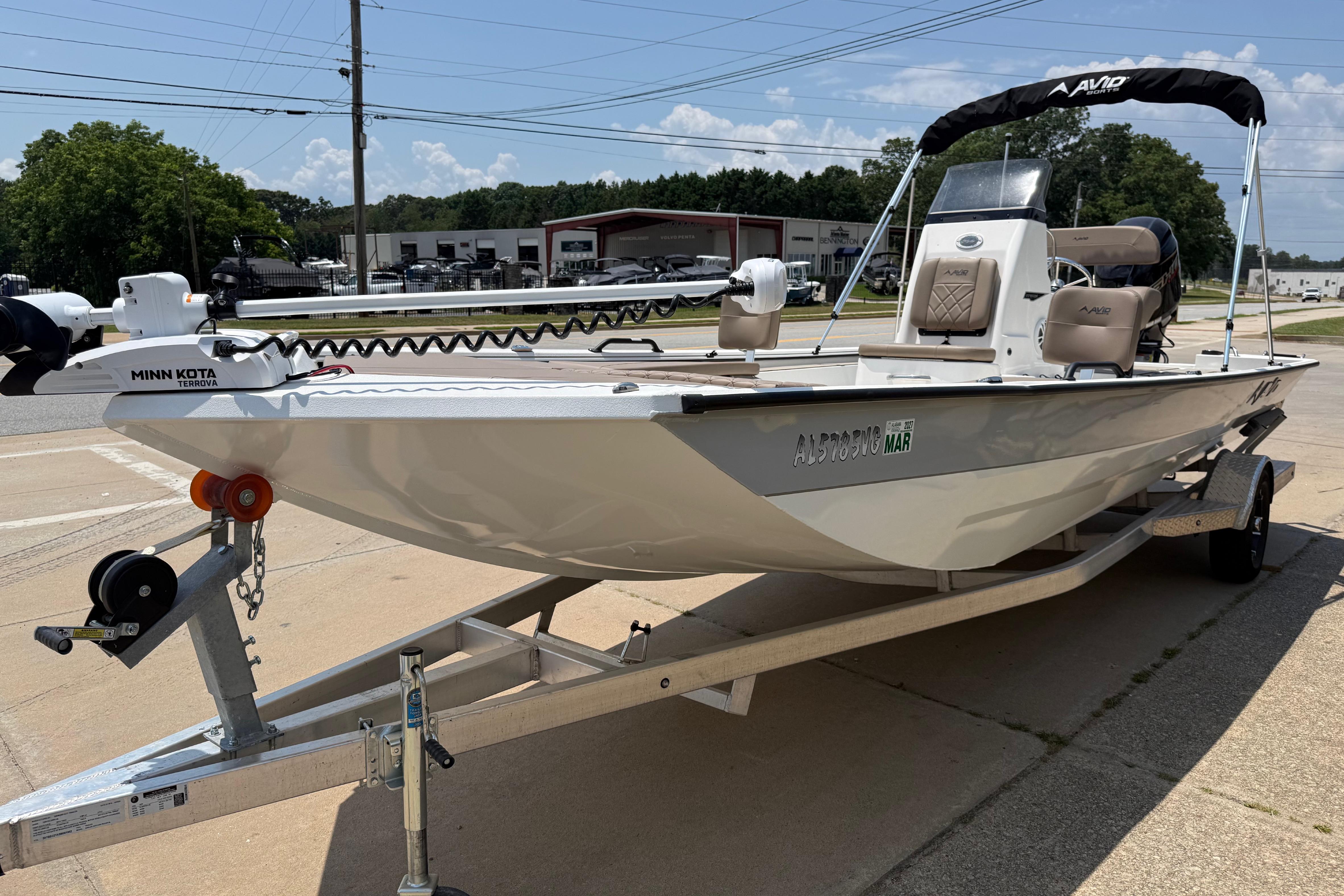 2025 Avid 22 Recon boat on trailer with Minn Kota motor, parked outdoors.