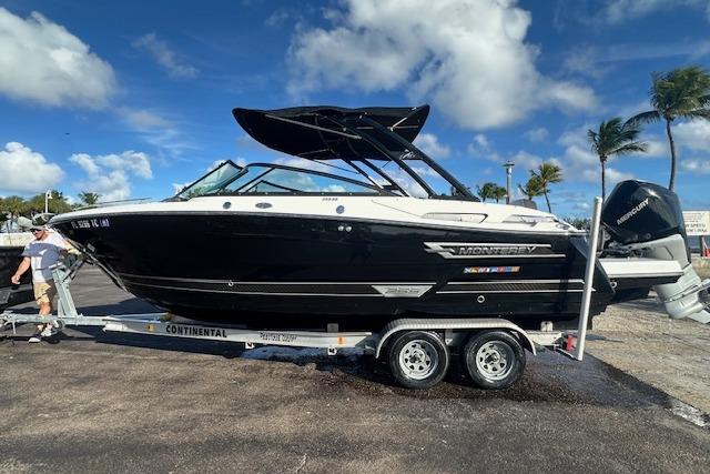 2022 Monterey 255SS Super Sport boat on trailer, parked outdoors under blue sky.