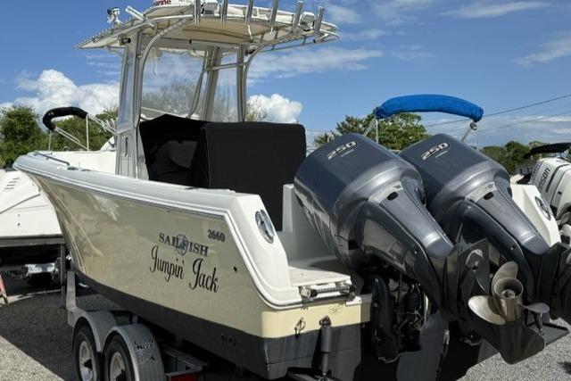 2006 Sailfish 2660 CC boat with dual outboard motors on a trailer.