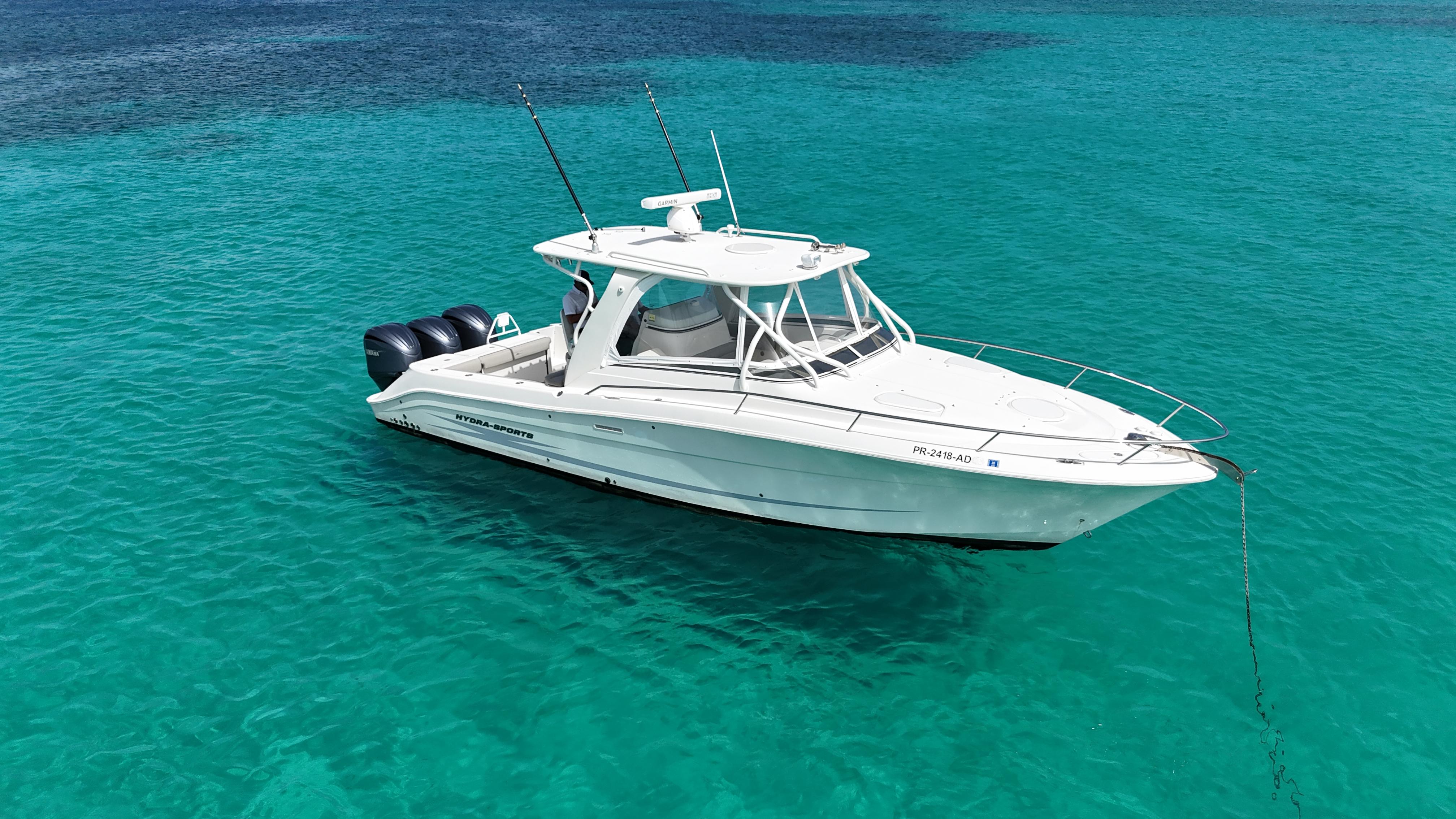 2009 Hydra-Sports 3500 VX boat anchored in clear turquoise water.