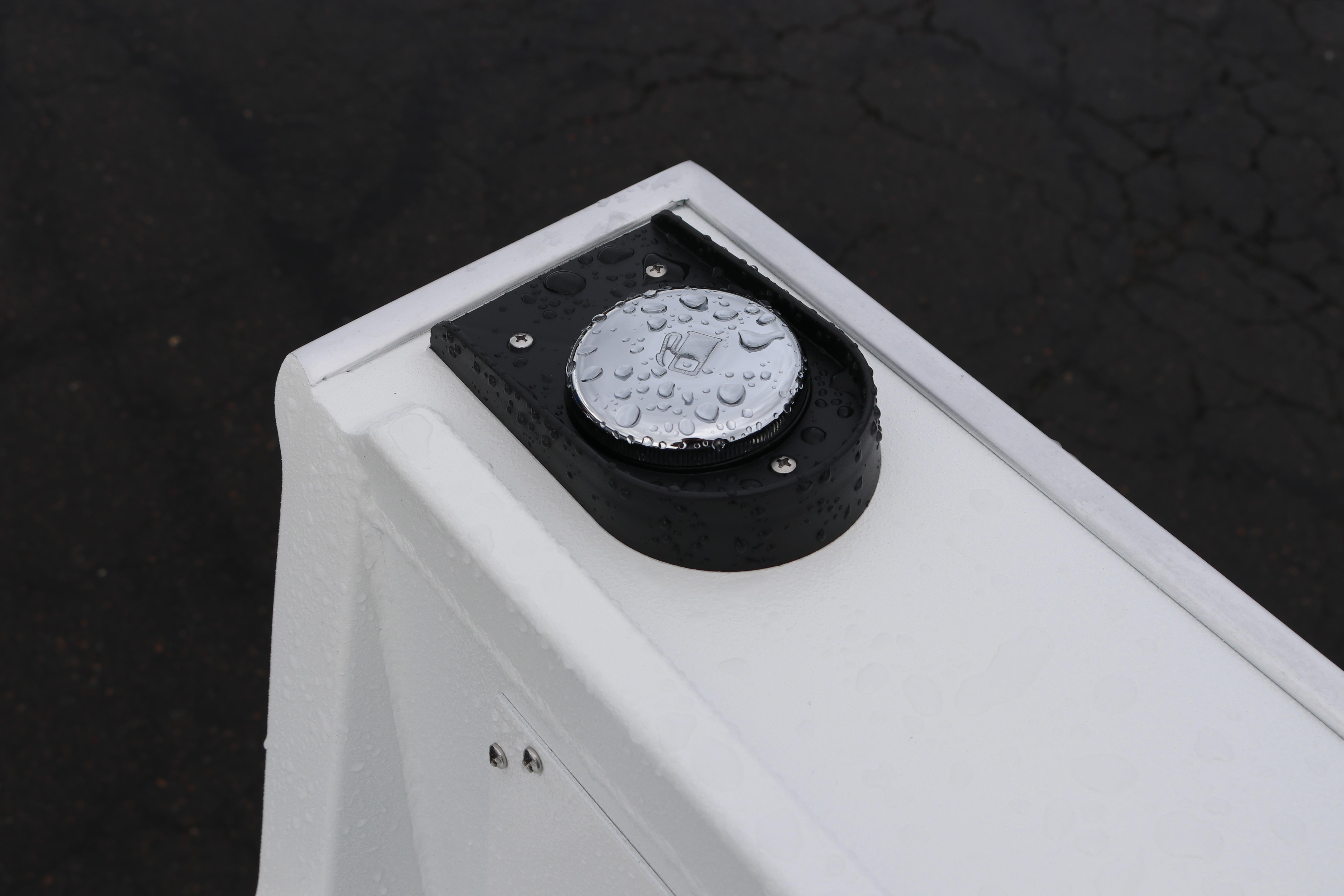 Close-up of Alumaweld Stryker 2026 boat detail with water droplets on a metal surface.