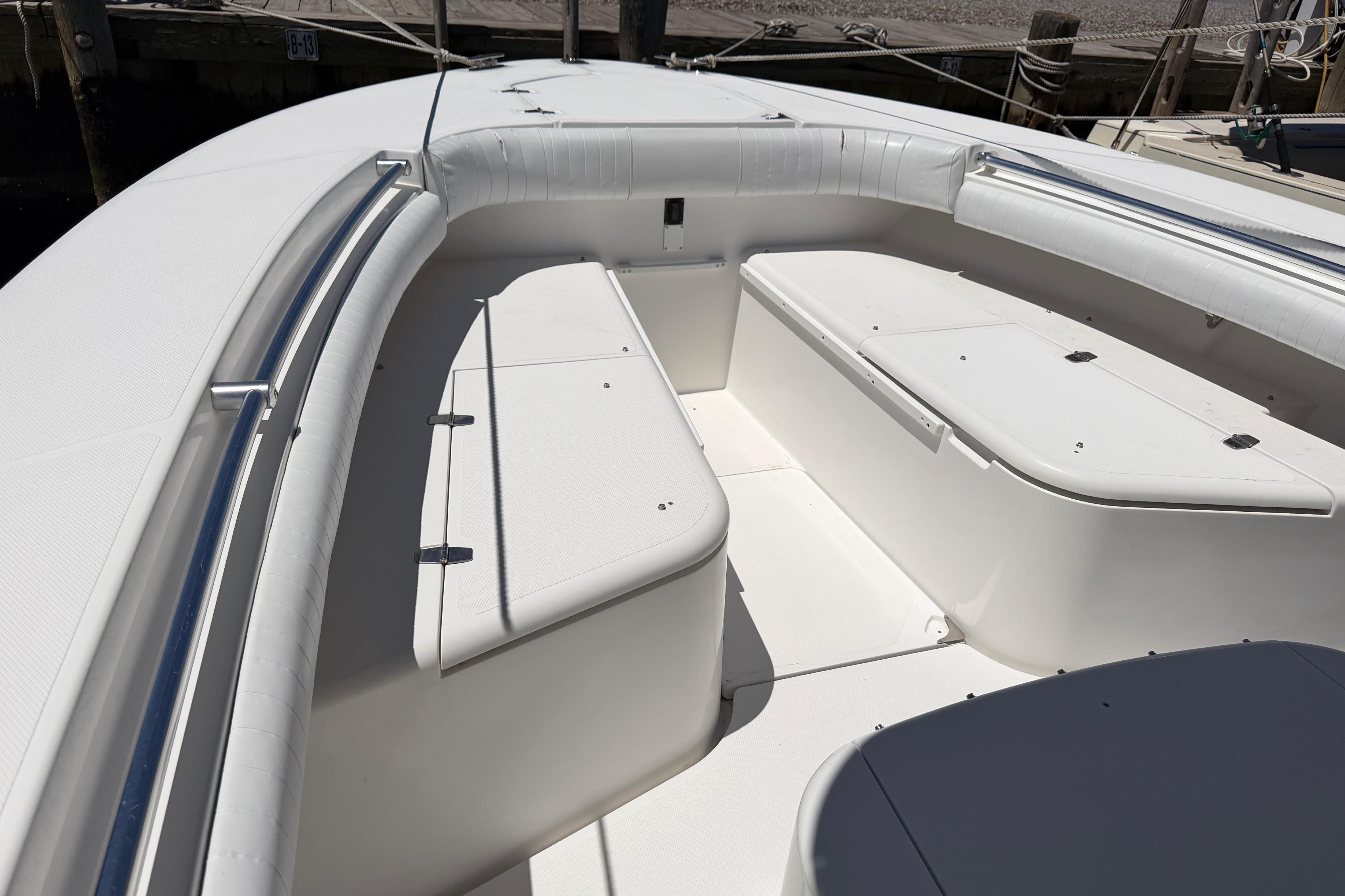2006 Southport 26 Center Console boat interior with white seating and storage compartments.
