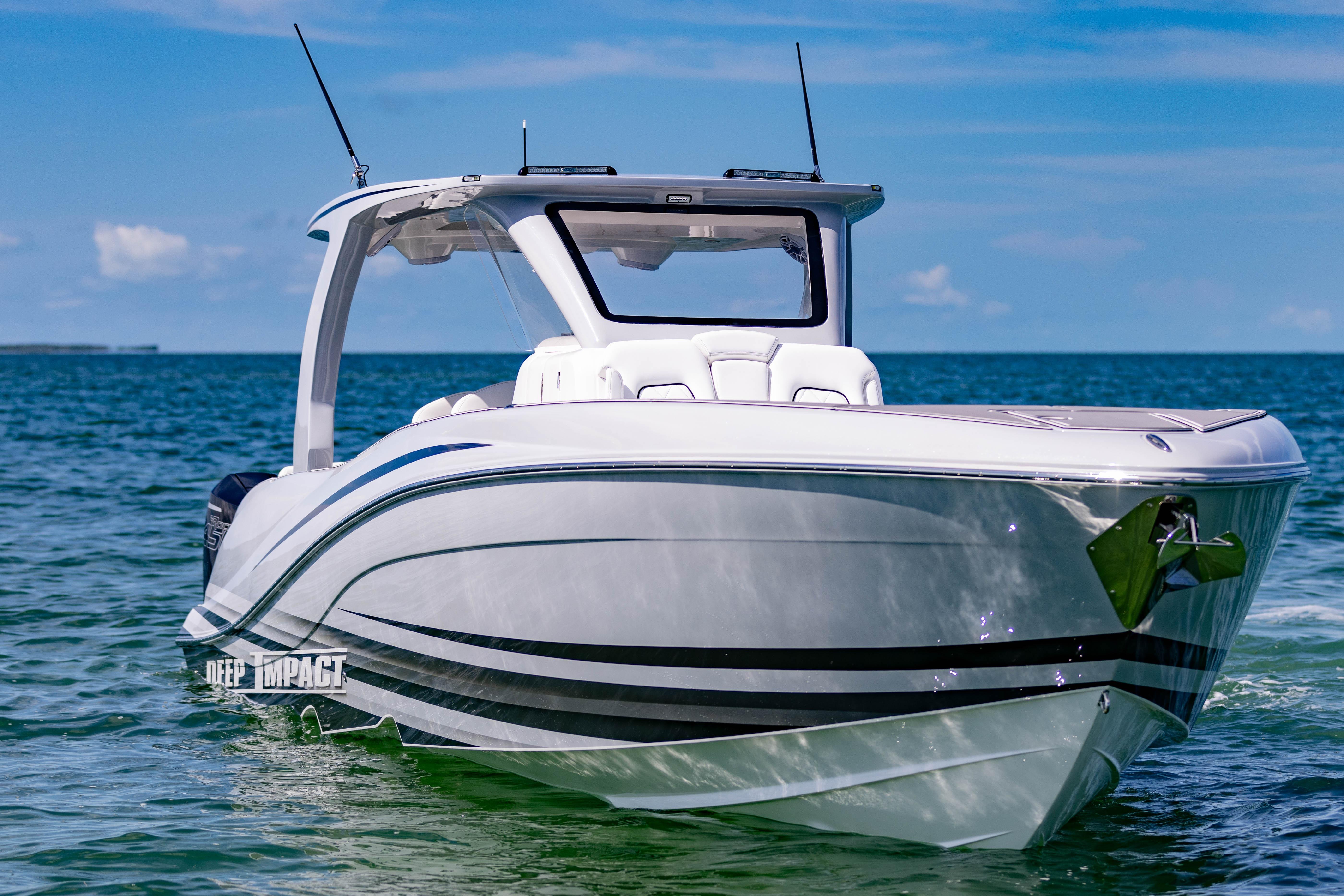 2024 Deep Impact 399 Sport boat on clear blue water under a sunny sky.