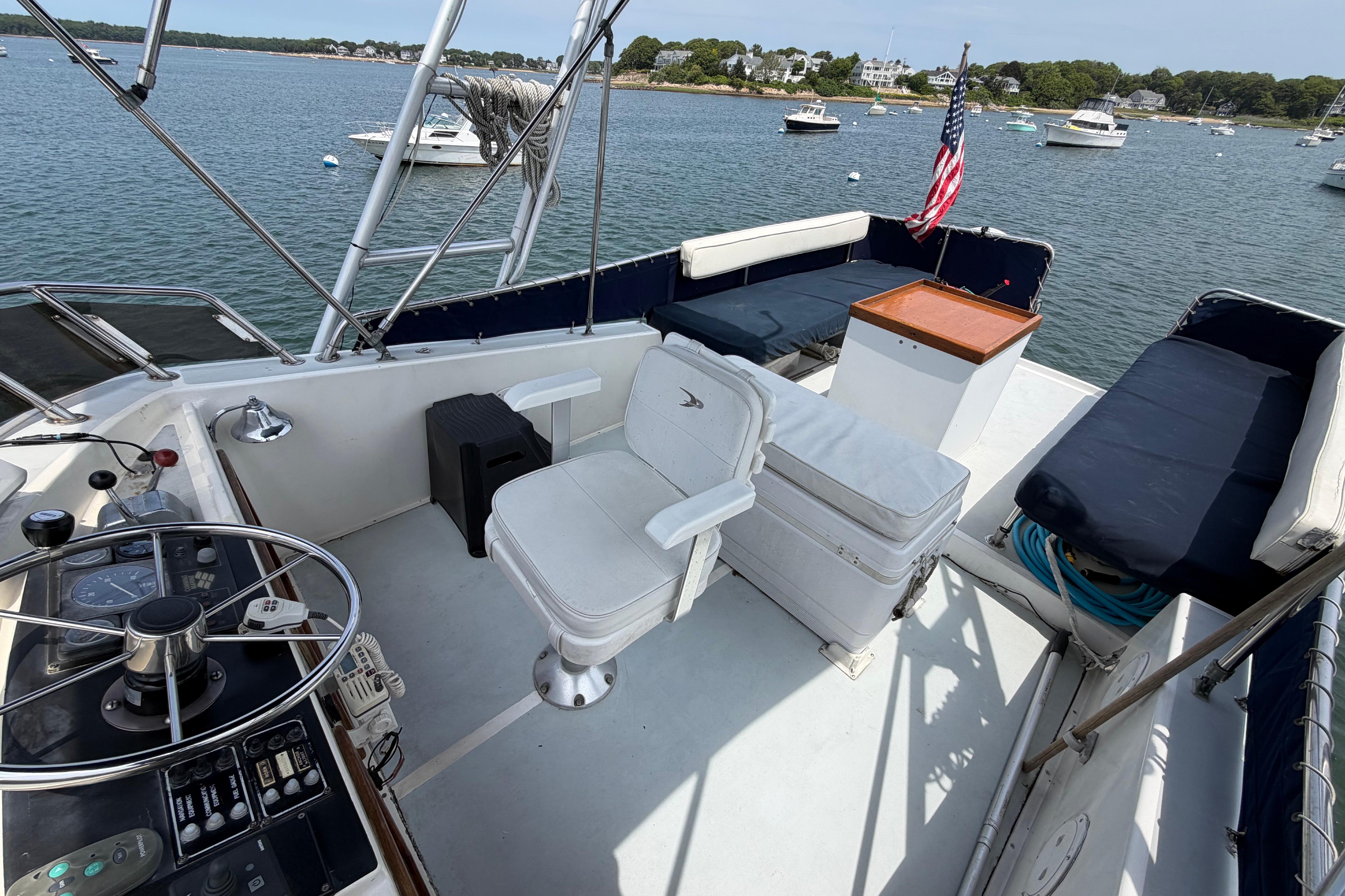 1986 Albin 34 Family Cruiser helm with seating, overlooking a scenic harbor.