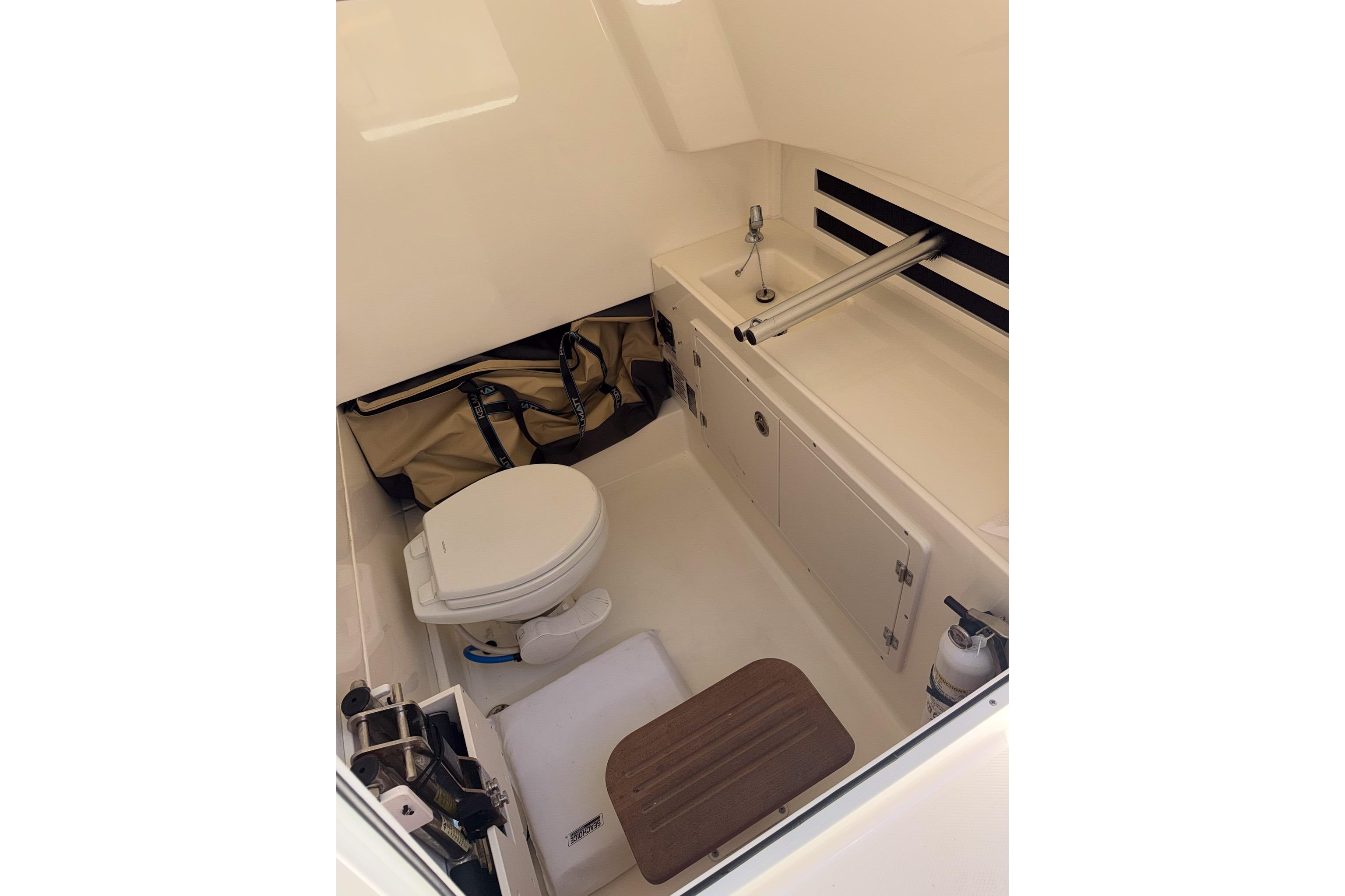 2021 Boston Whaler 330 Outrage cabin interior with toilet and sink.