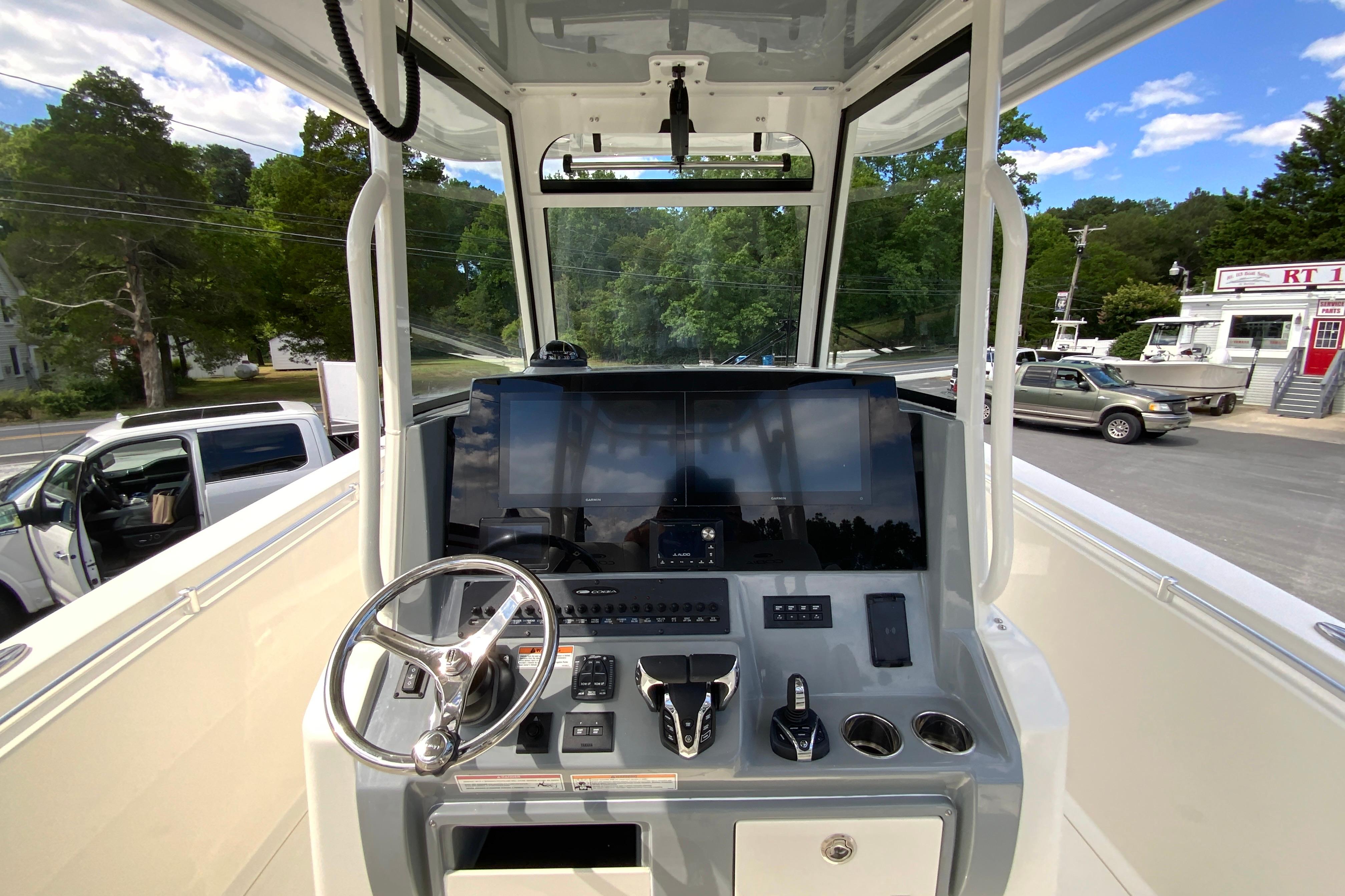 2027 Cobia 320 Center Console boat dashboard with steering wheel and modern controls.