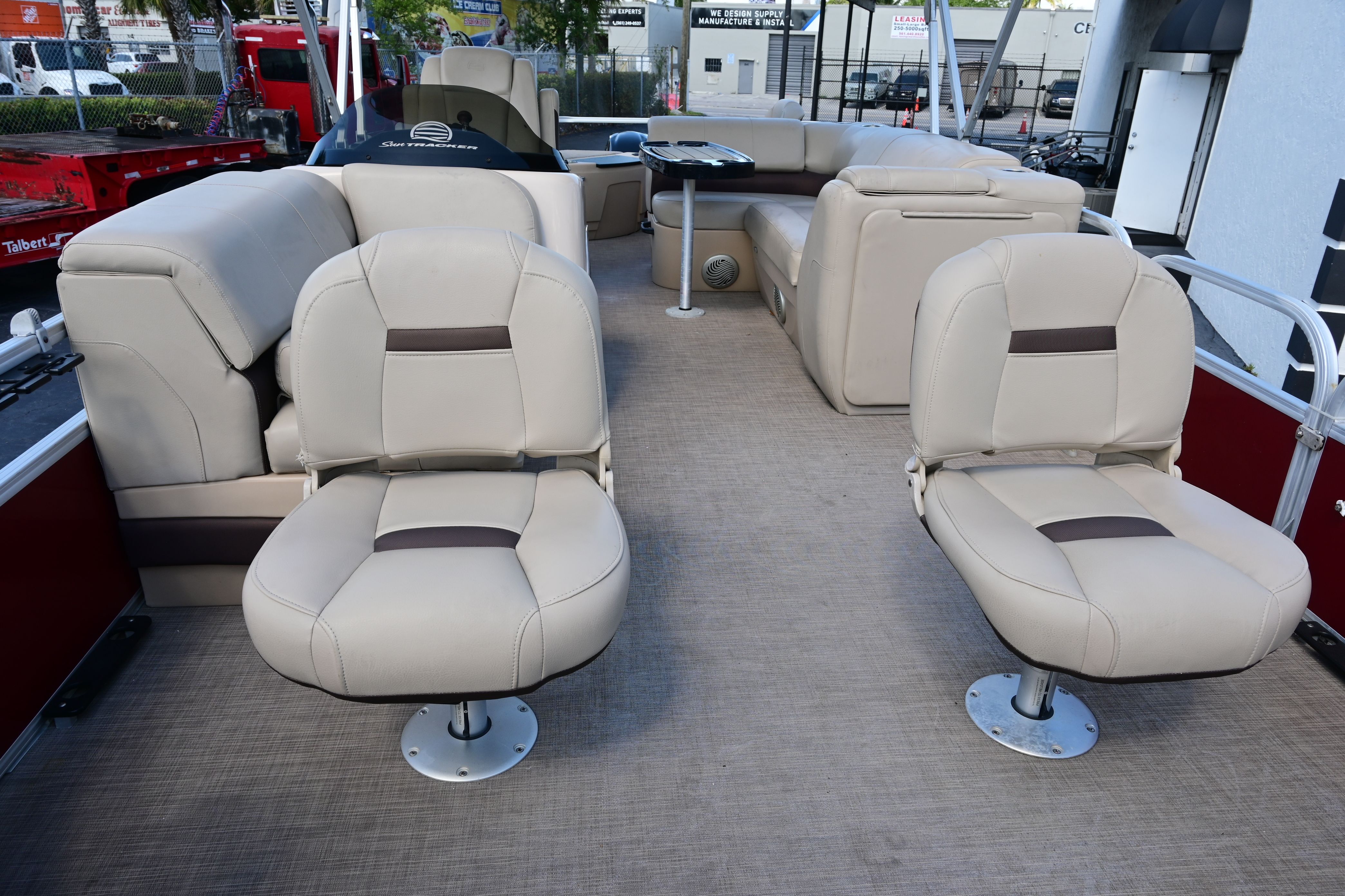 Interior of a 2019 Sun Tracker FISHI pontoon boat with beige seating.