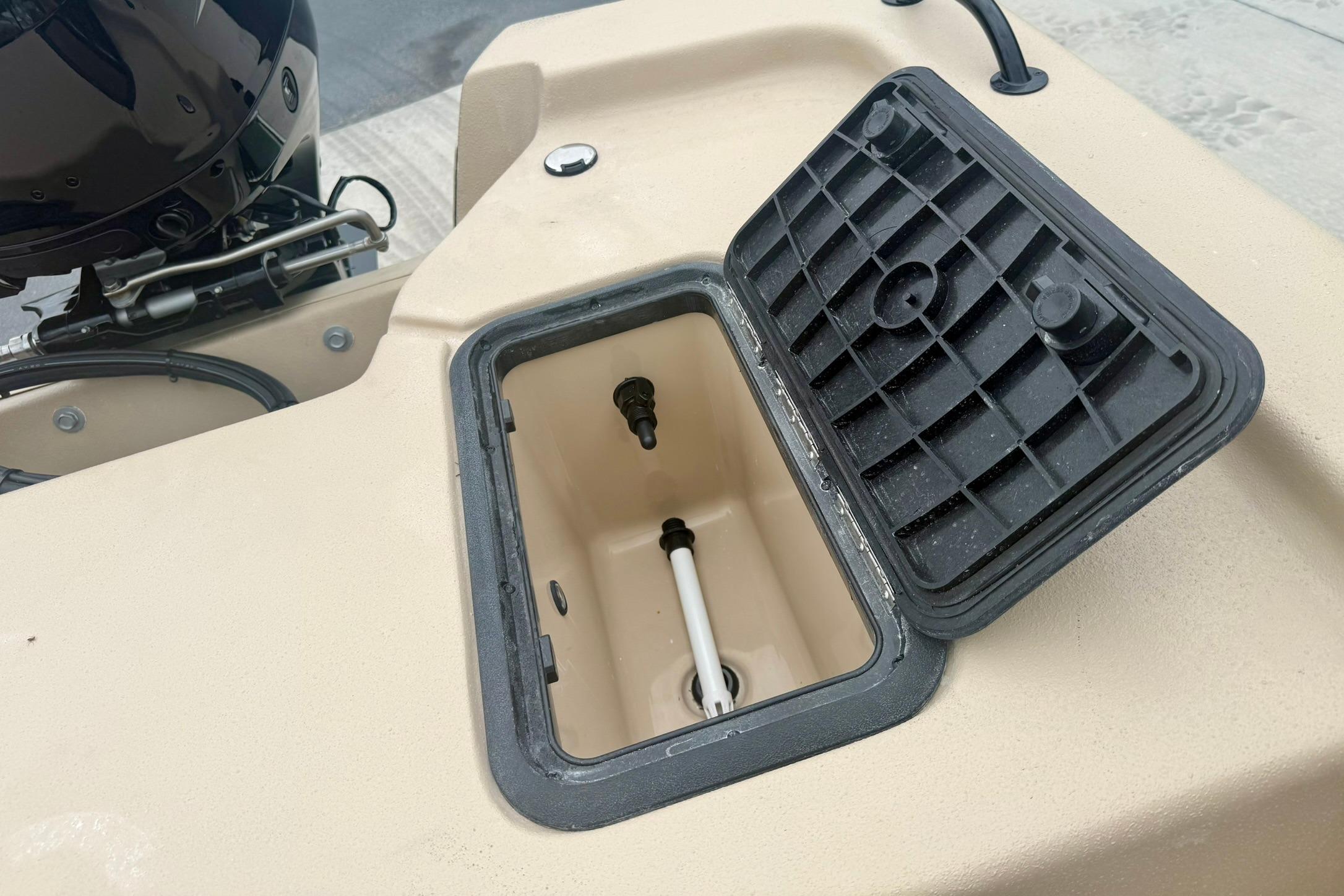 Open storage compartment on 2026 Carolina Skiff E18 JVX CC boat.