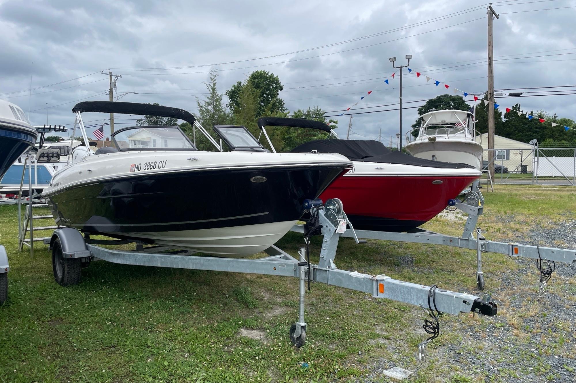 2023 Bayliner VR4 Bowrider OB on trailer, parked outdoors under cloudy sky.
