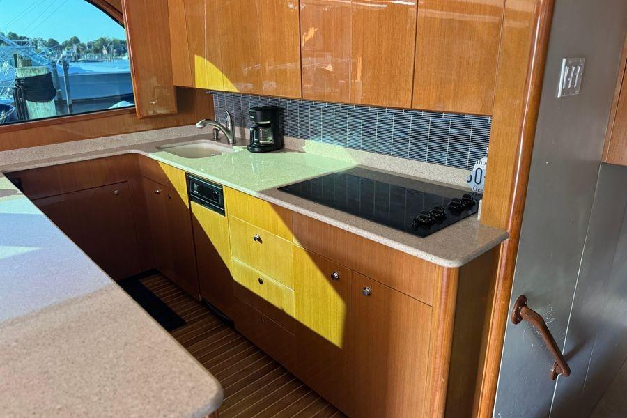 Luxurious kitchen in 2002 Viking 61 Enclosed Bridge yacht with modern appliances.