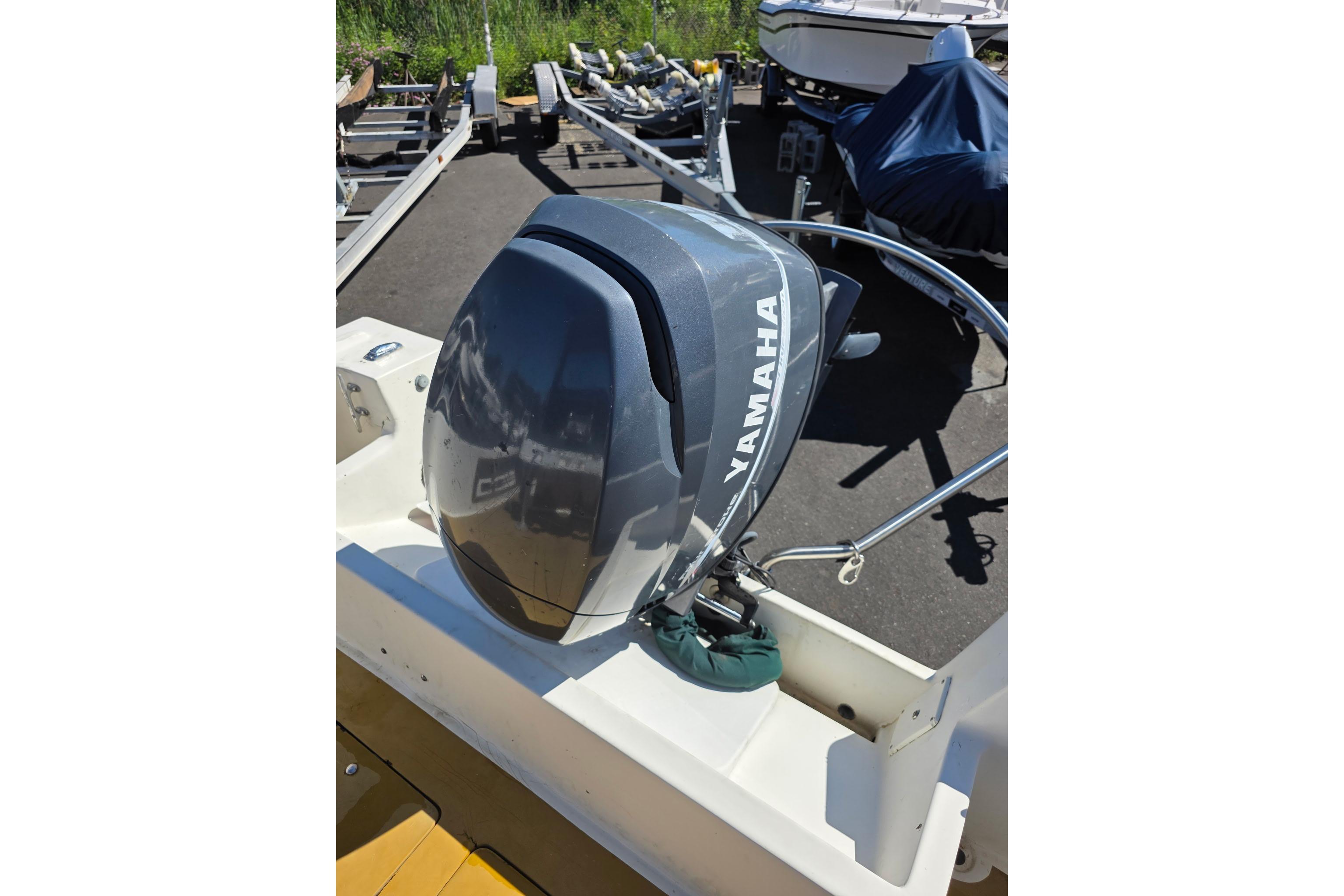 1982 Mako 20 Center Console with Yamaha outboard motor in a boatyard.
