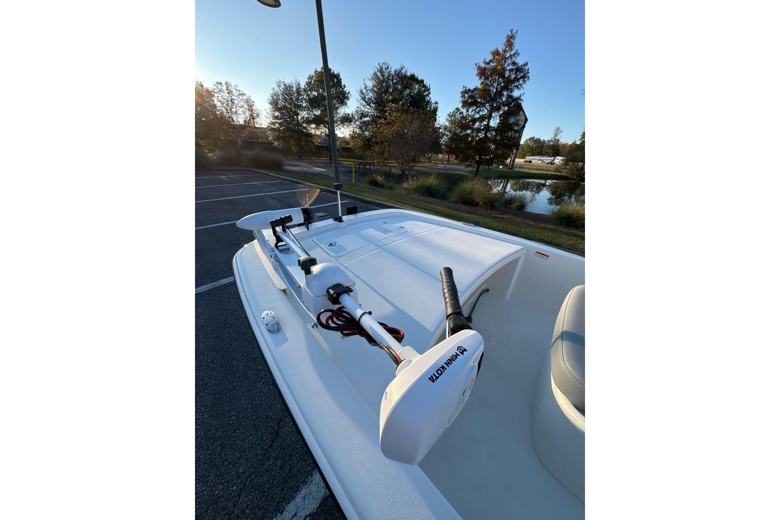 2026 Mako Pro Skiff 13 CC boat with Minn Kota trolling motor in a scenic outdoor setting.