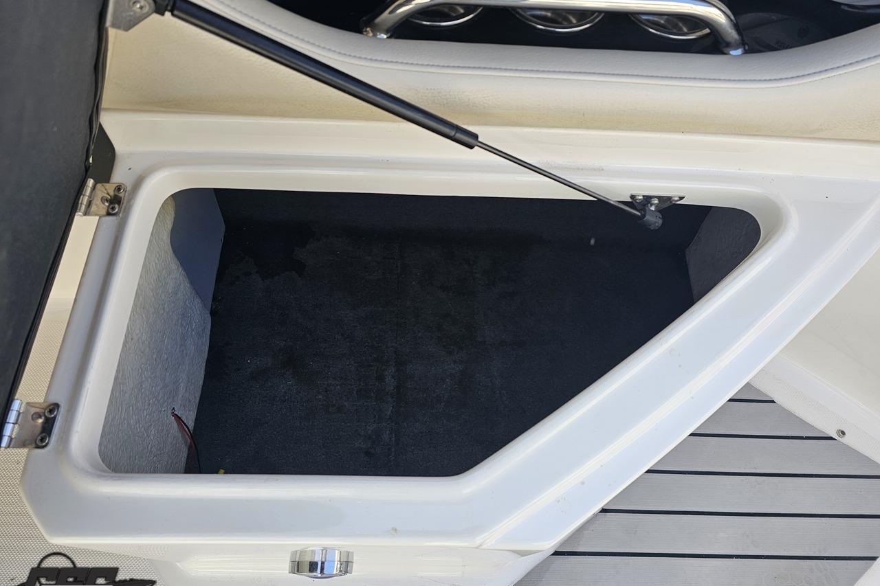 Open storage compartment on a 2008 Regal 2520 FasDeck boat.