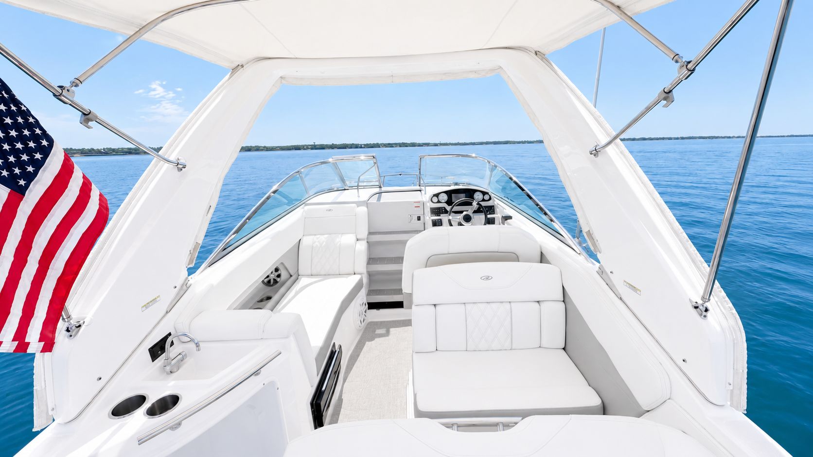 The image shows the cockpit of a 2020 Regal 28 Express boat on calm water.