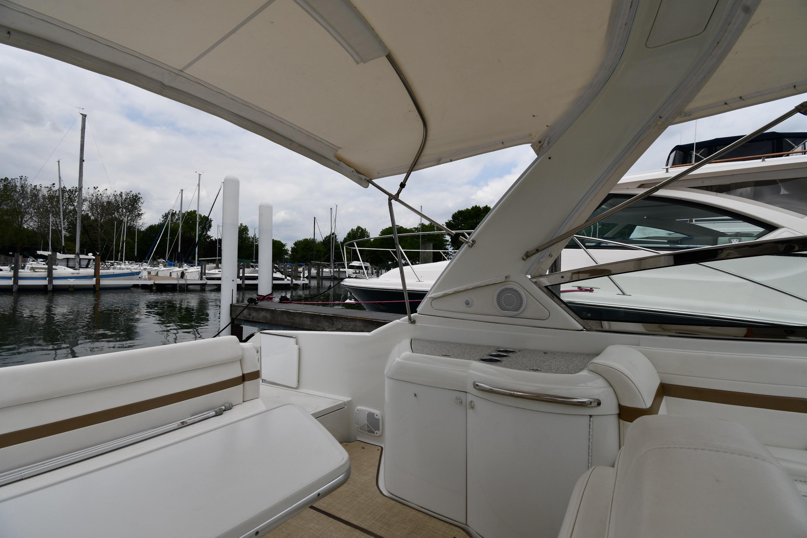 2004 Formula 330 Sun Sport boat interior at marina with sailboats in background.
