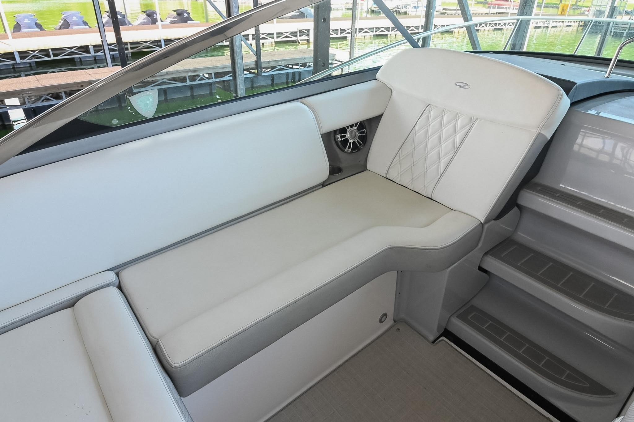 2021 Regal 33 Express boat interior with white cushioned seating and sleek design.