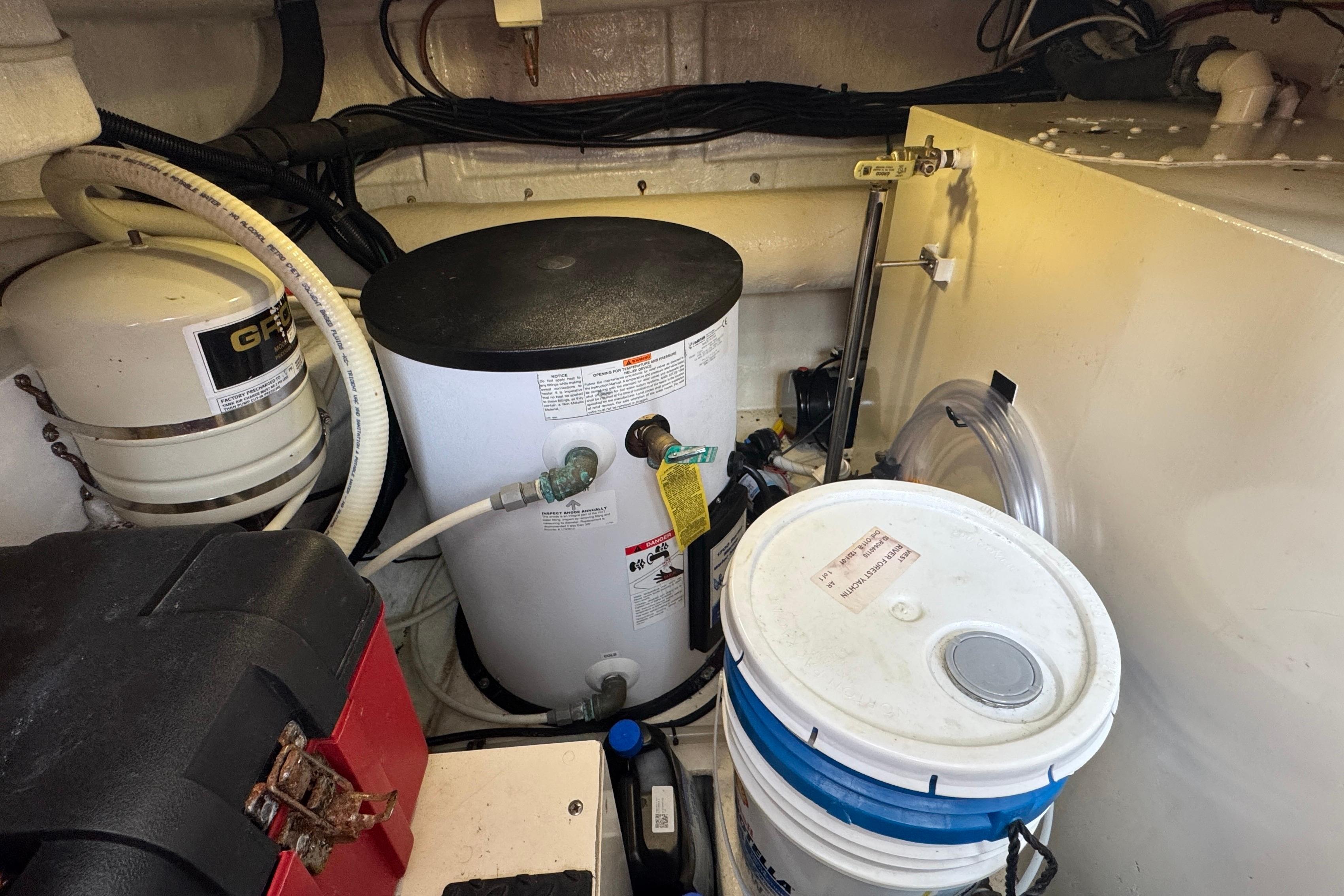 Engine room of 2007 Jefferson Pilothouse 52 SE with equipment and storage containers.
