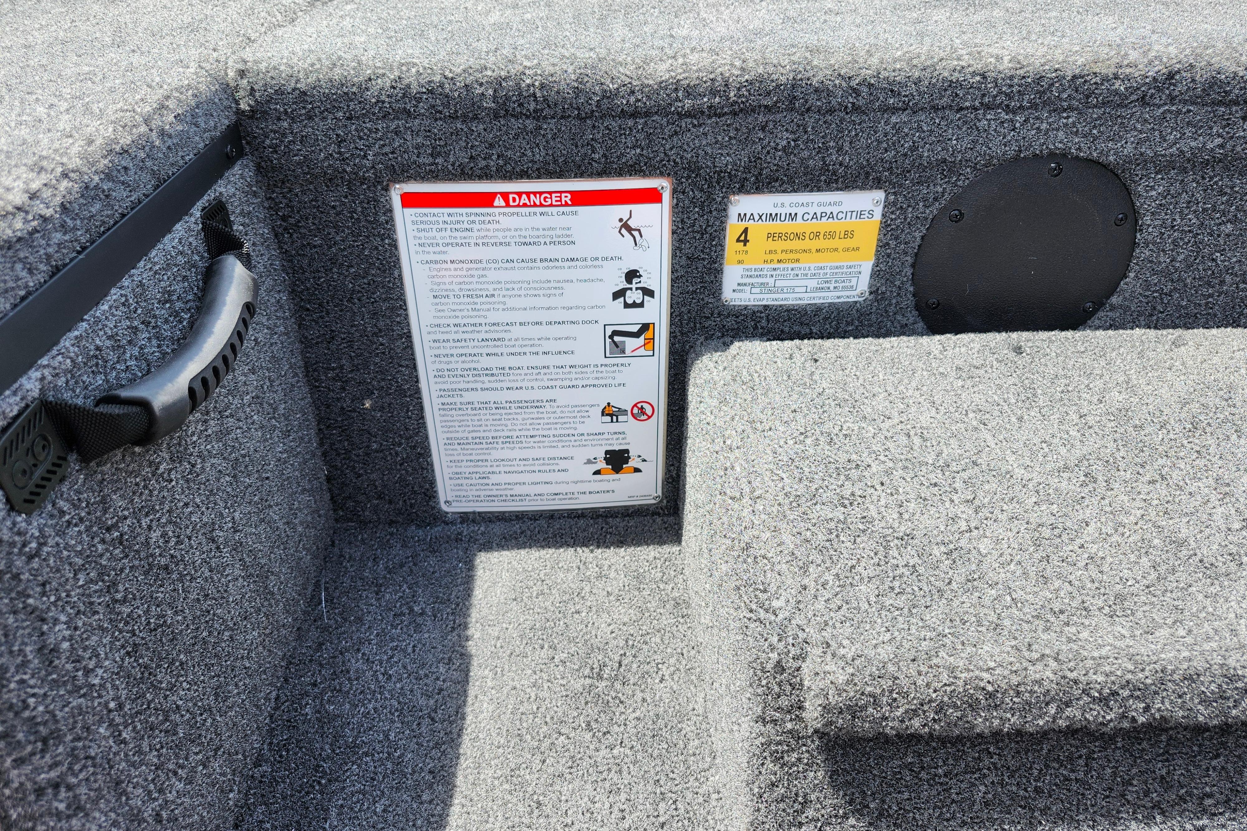 Safety warnings and capacity labels on 2026 Lowe Stinger 175C boat interior.