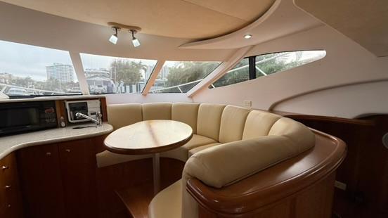 Interior of 2001 Silverton 410 Sport Bridge yacht with cozy seating and modern amenities.