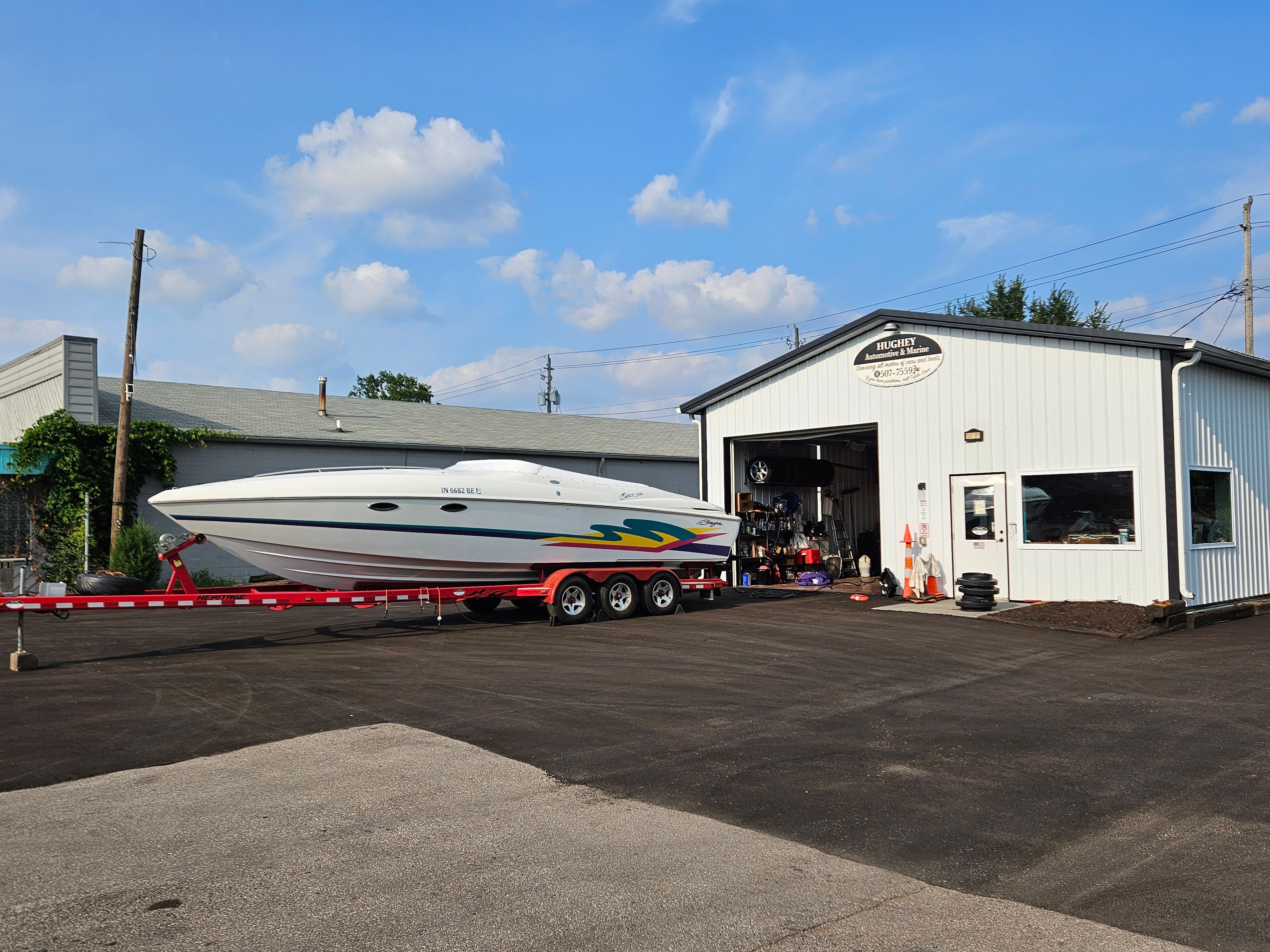 A 1996 Baja 302 Boss on a trailer in front of a white building.