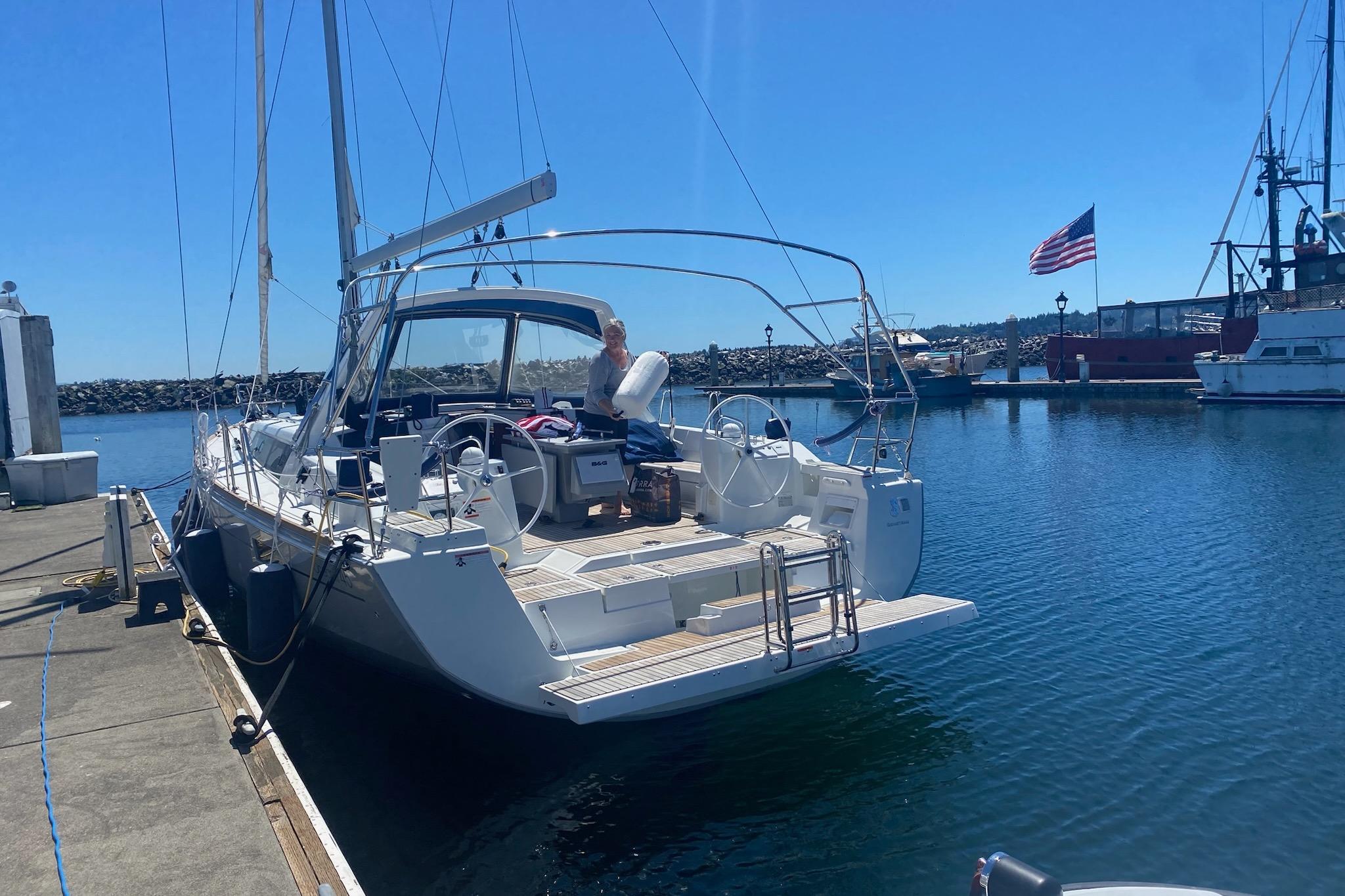 2018 Beneteau Oceanis 45 yacht docked at marina under clear blue sky.